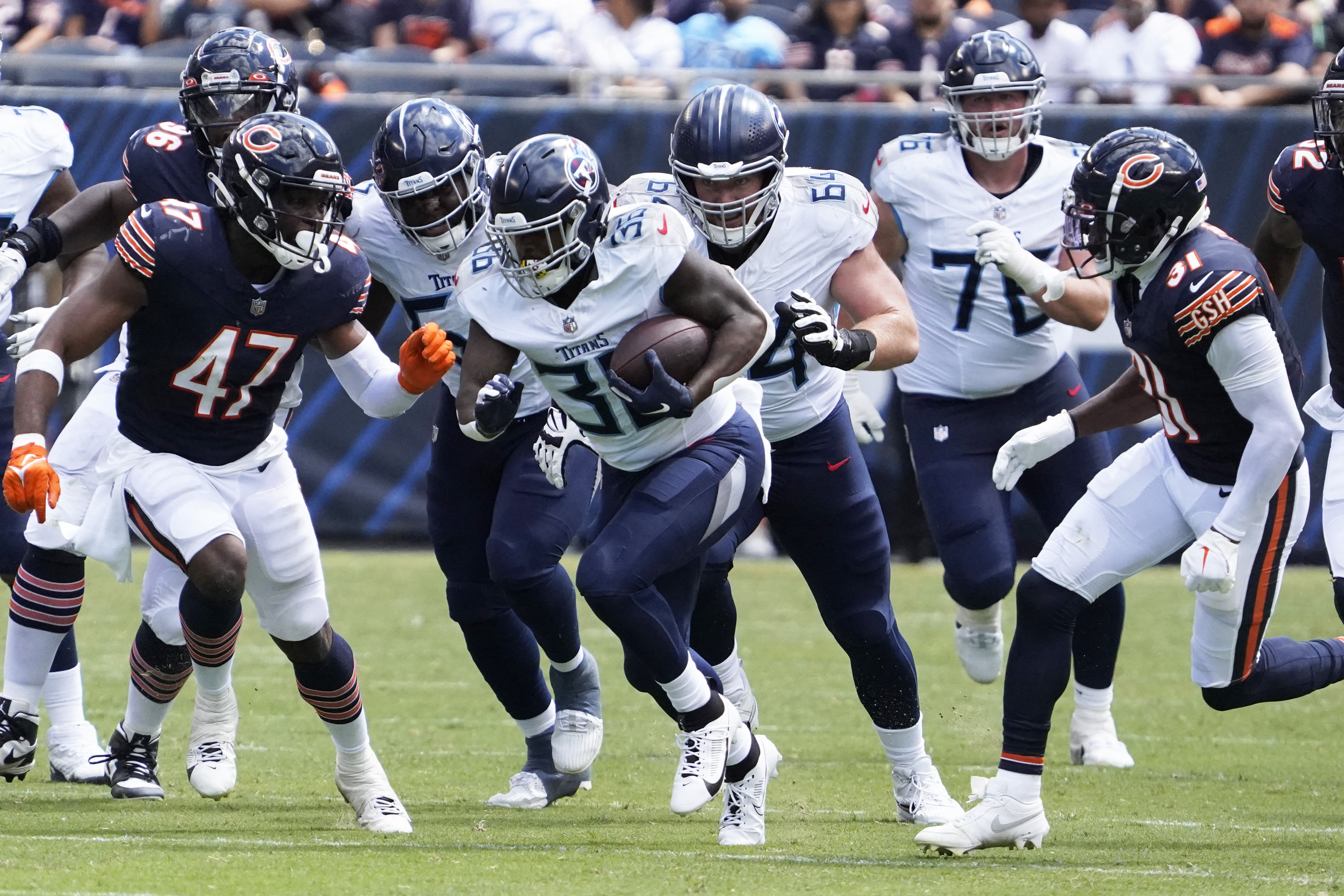 Chicago Bears defensive back Tre Roberson, left, scores a touchdown after  intercepting a pass against the Tennessee Titans in the first half of a  preseason NFL football game Saturday, Aug. 28, 2021