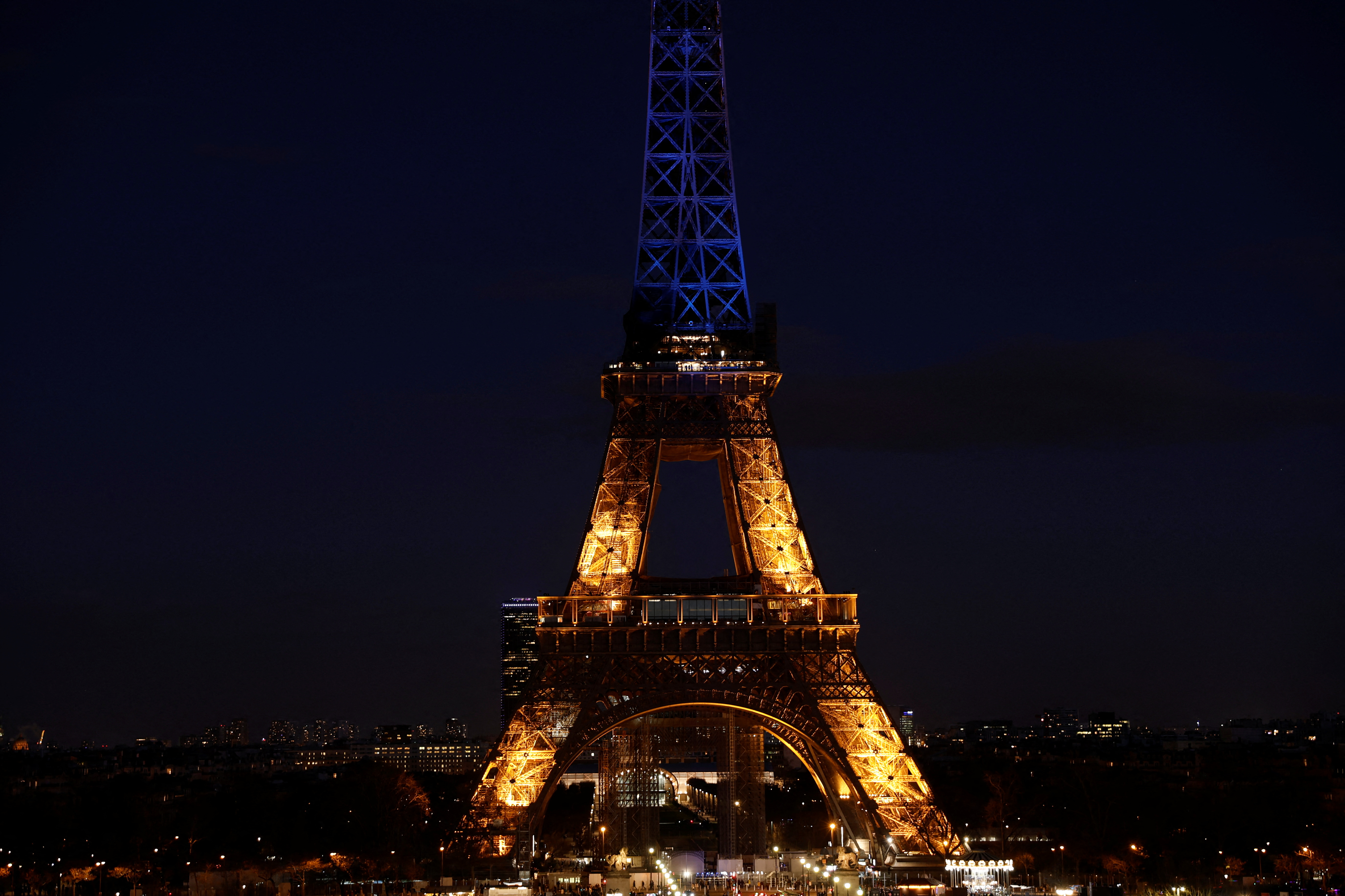 The Eiffel Tower is lit up in blue and yellow, in support of the Ukrainian people, in Paris