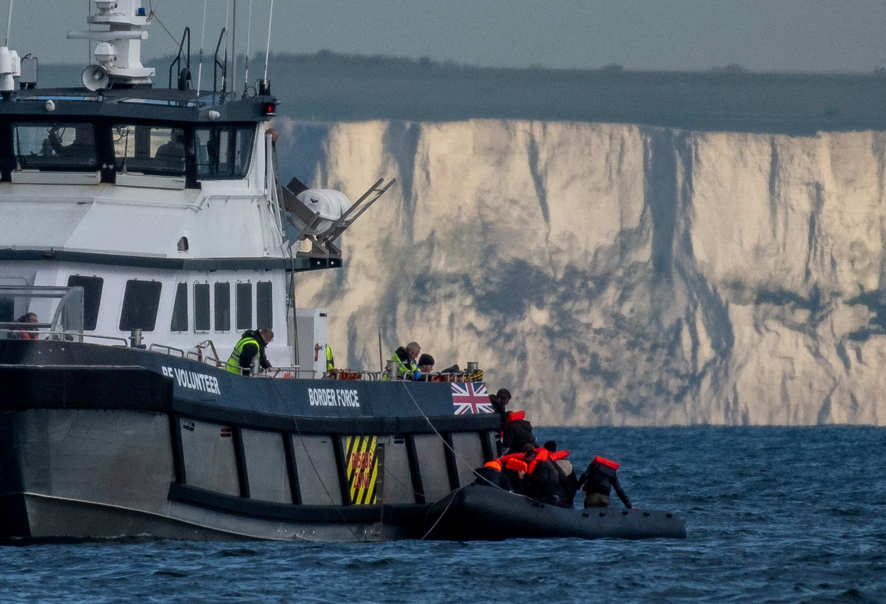 Migrants cross the English Channel in small boats