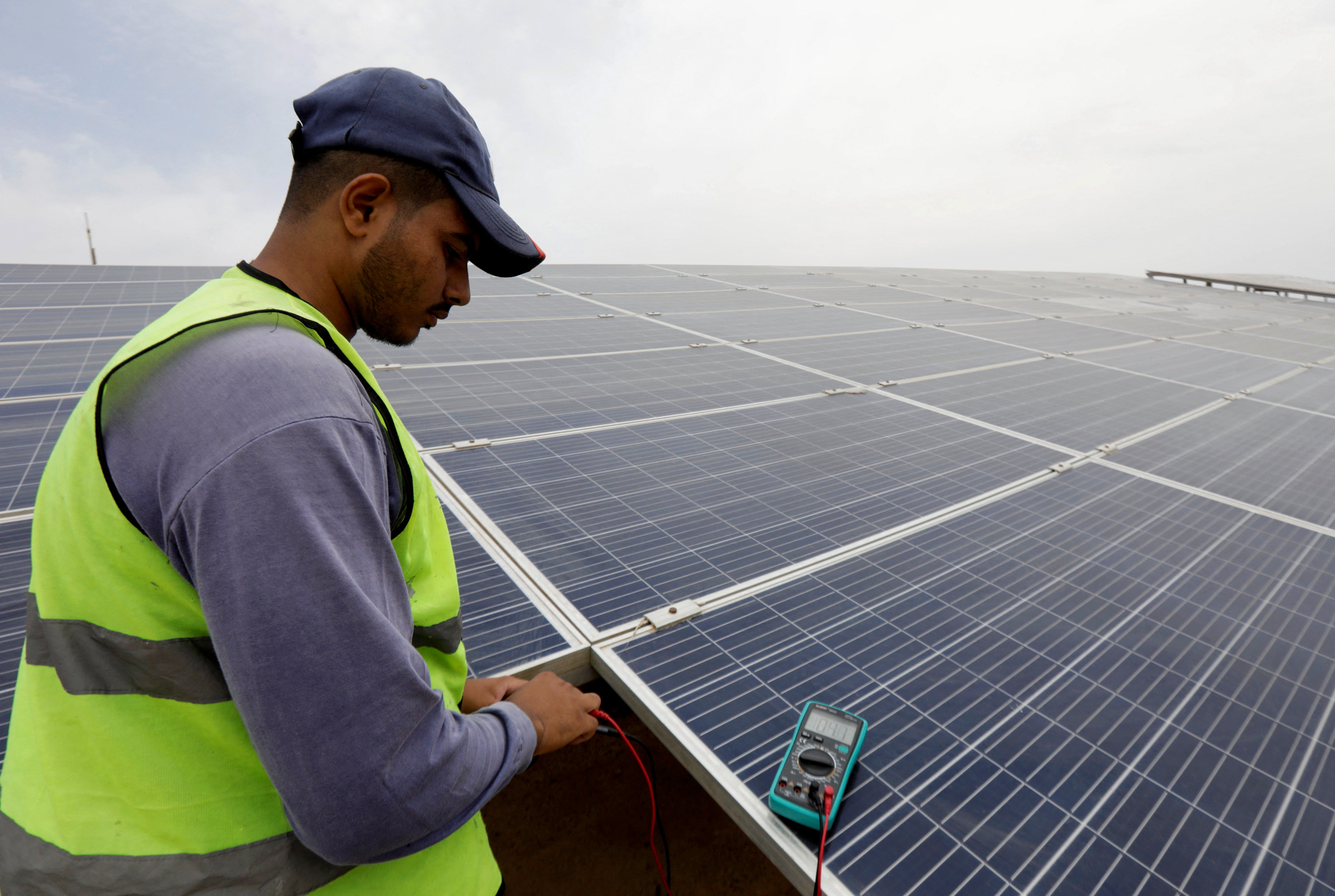 A worker checks solar cells on the rooftop of a hotel in the resort town of Sharm el-Sheikh