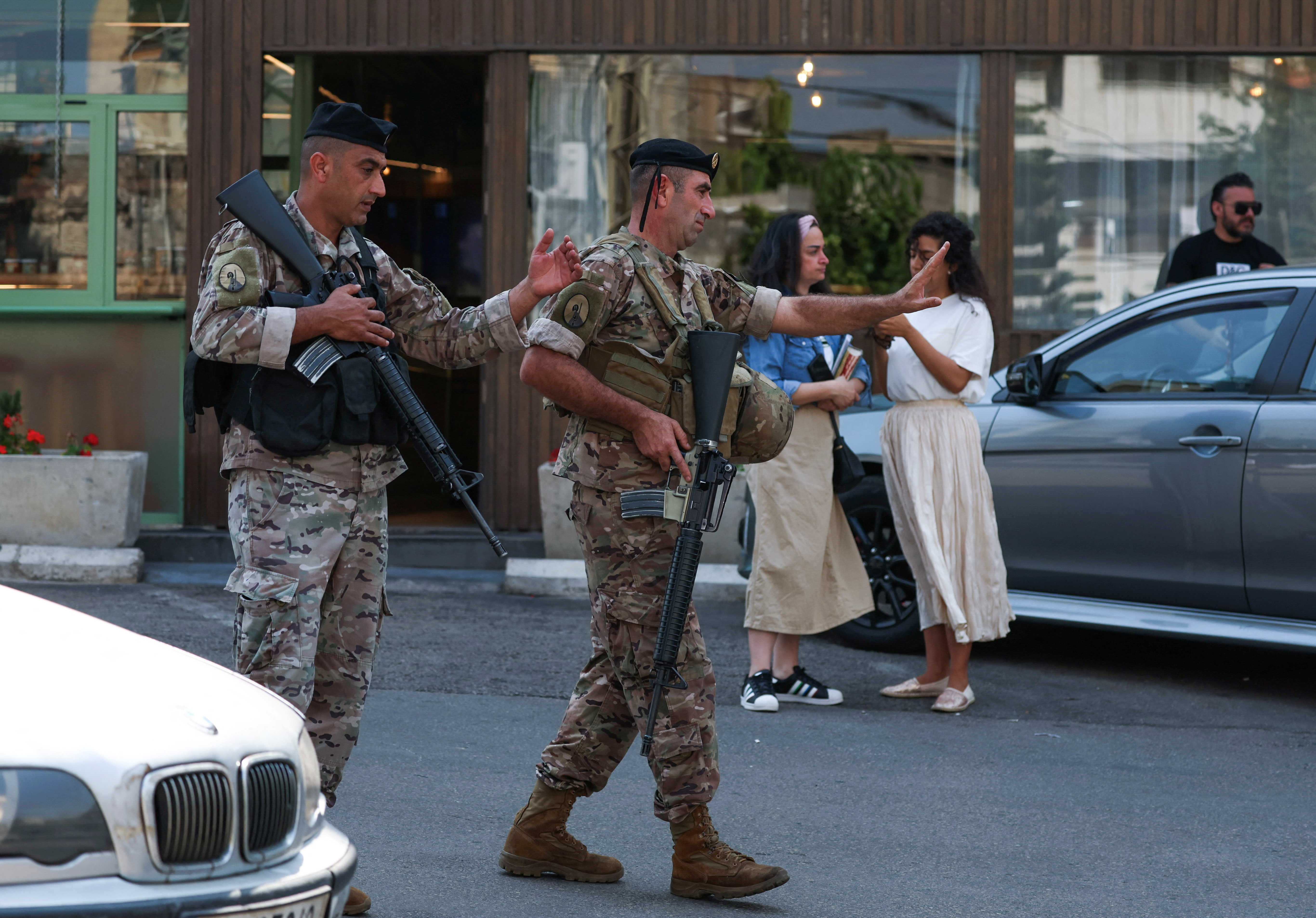 Lebanese army soldiers gesture as they secure the area near the U.S. embassy in Awkar