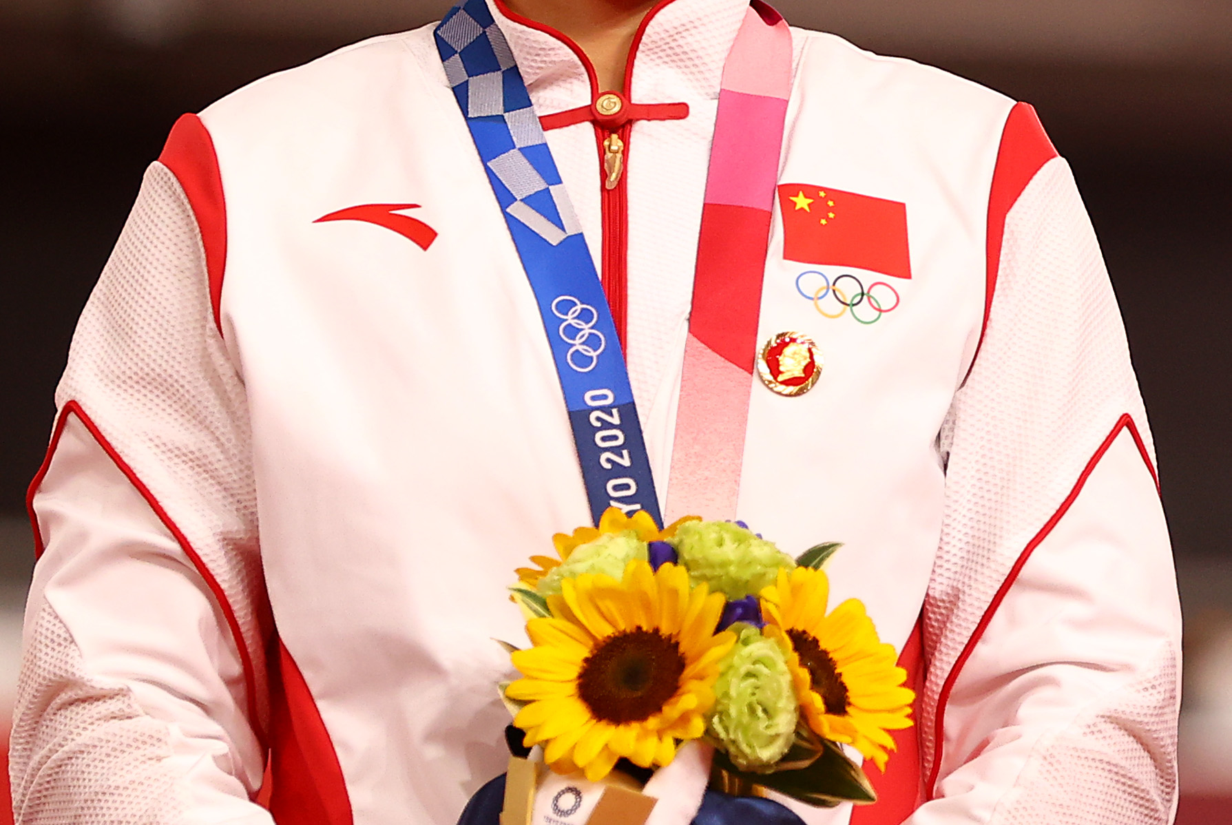 Tokyo 2020 Olympics - Cycling - Track - Women's Team Sprint - Medal Ceremony - Izu Velodrome, Shizuoka, Japan - August 2, 2021.  A badge of the late Chinese chairman Mao Zedong is seen pinned to the tracksuit of gold medallist, Bao Shanju of China REUTERS/Matthew Childs