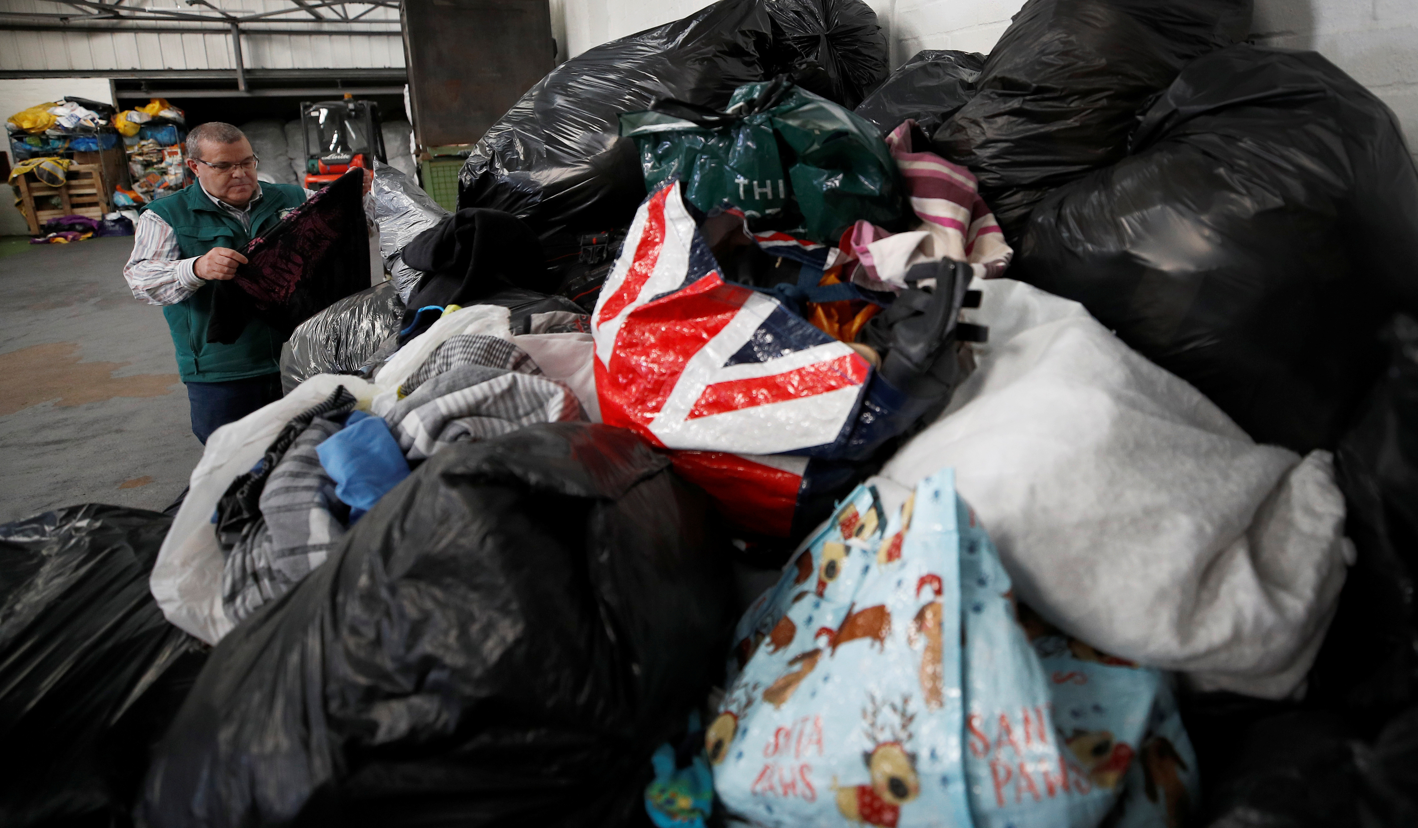 Bags of clothing are manually sorted through at a recycling facility in
Stourbridge, Britain.