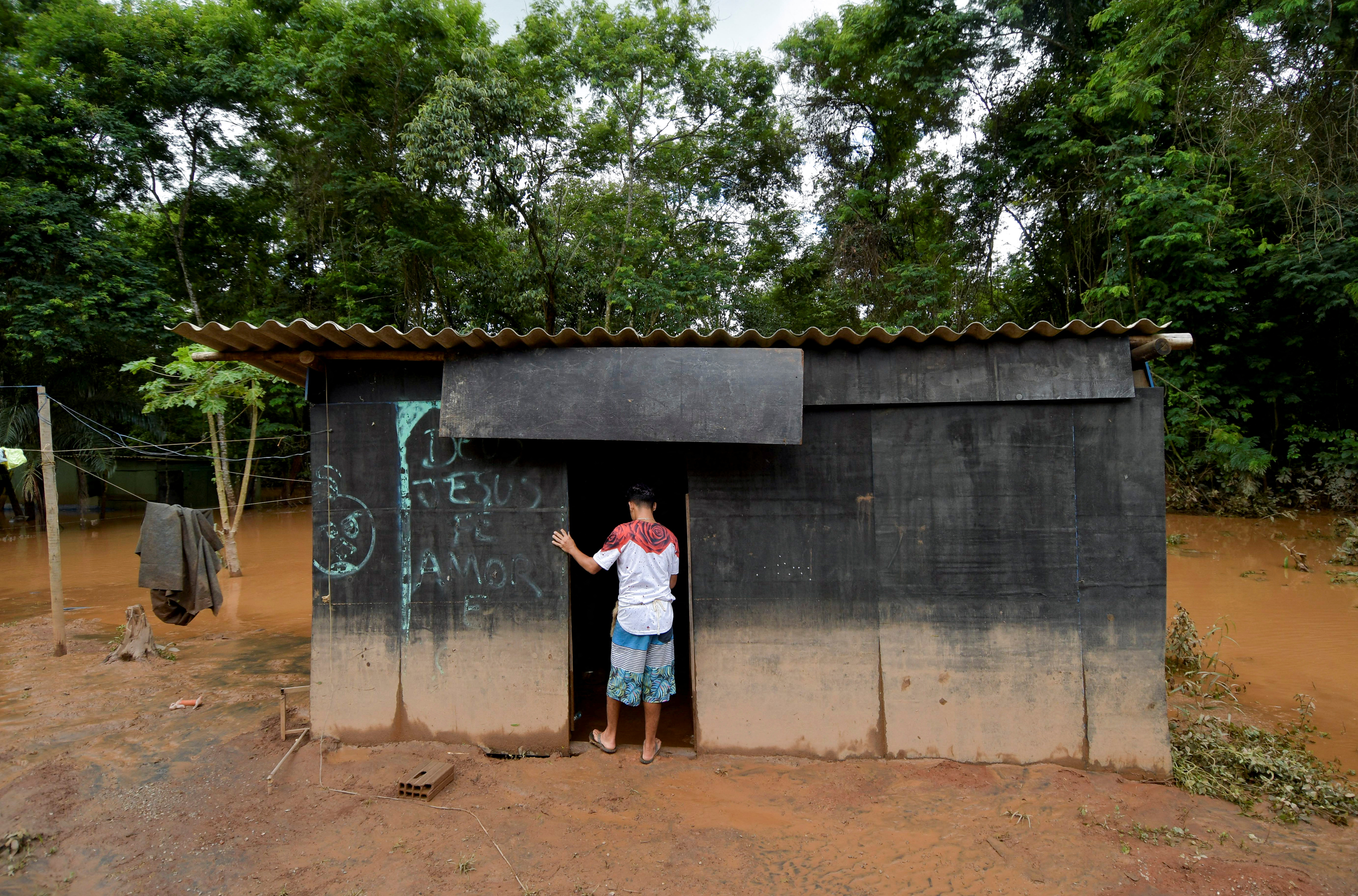 An indigenous man of the Pataxo ethnicity observe flooding in Nao Xoha village after pouring rains, in Sao Joaquim de Bicas, Minas Gerais state, Brazil January 12, 2022. REUTERS/Washington Alves