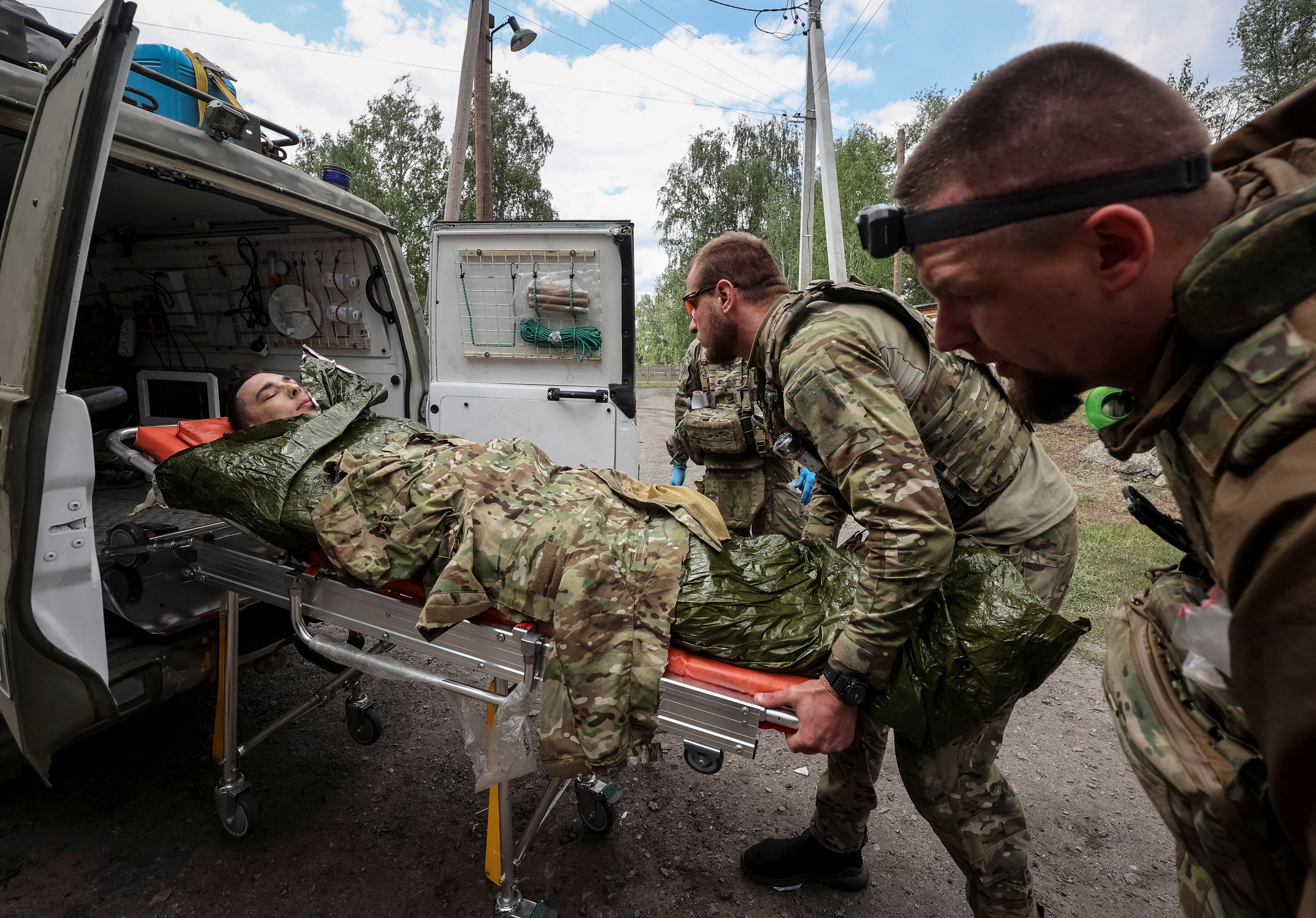 Military paramedics treat a wounded Ukrainian service member near the town of Vovchansk