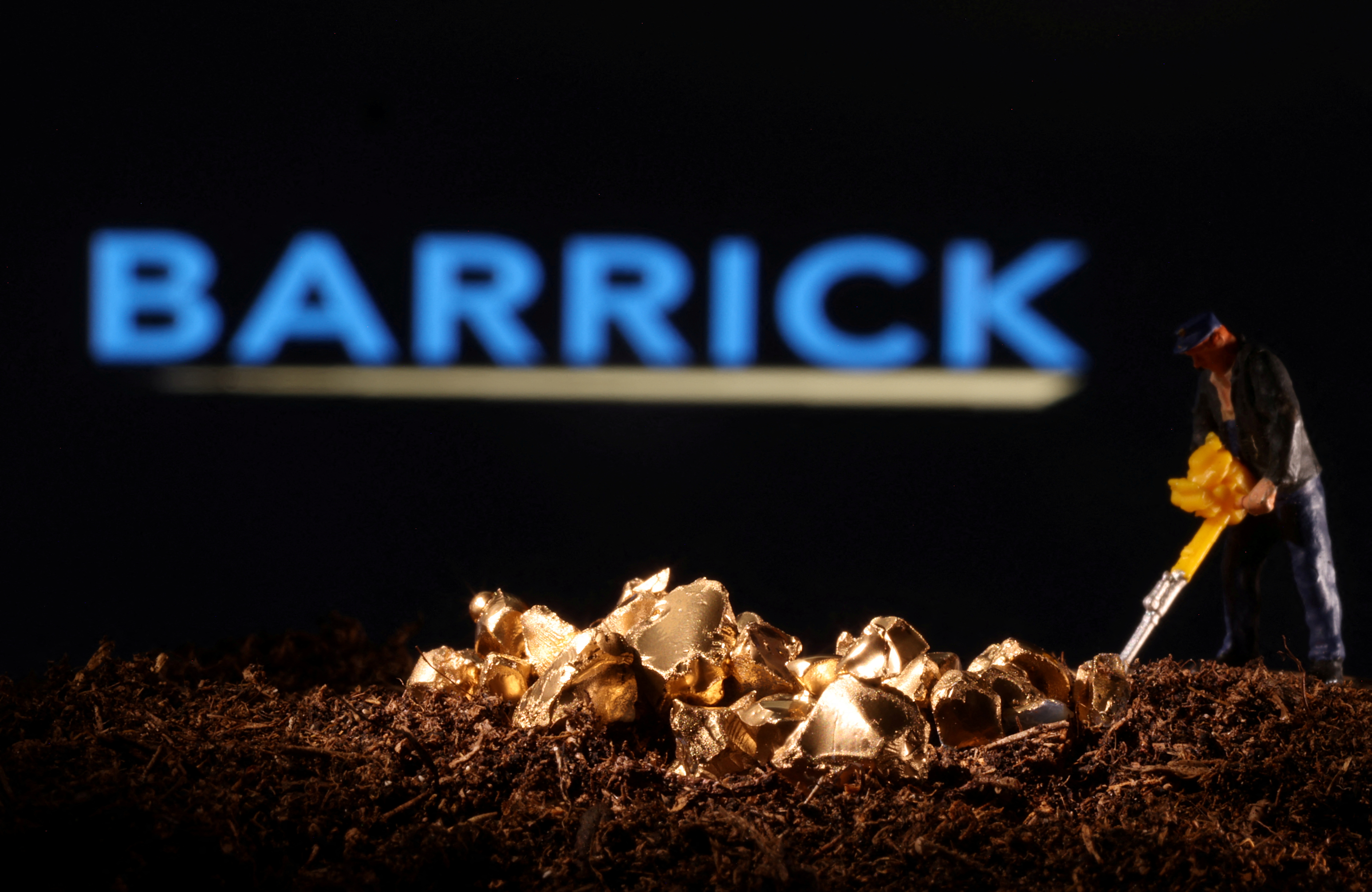 Small toy figure and gold imitation are seen in front of the Barrick logo in this illustration