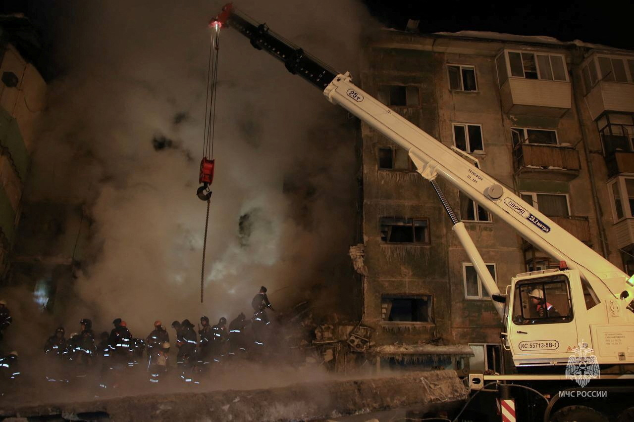 Rescuers remove the rubble of a five-floor residential building heavily damaged in a gas explosion in Novosibirsk