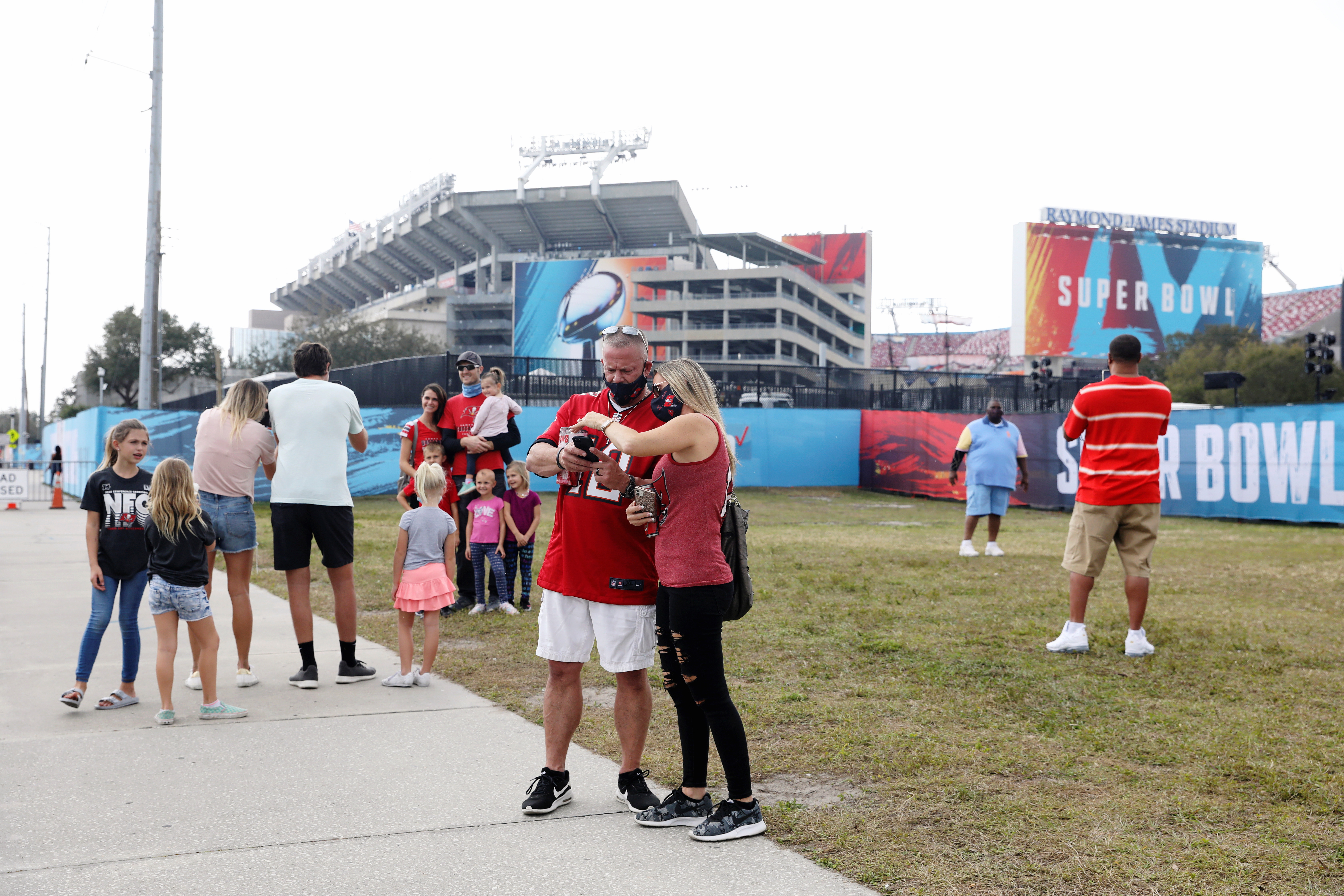 NFL fans spend time around the exterior of Raymond James Stadium ahead of the weekend's Super Bowl LV between the Kansas City Chiefs and Tampa Bay Buccaneers in Tampa, Florida, U.S., February 6, 2021.  REUTERS/Eve Edelheit