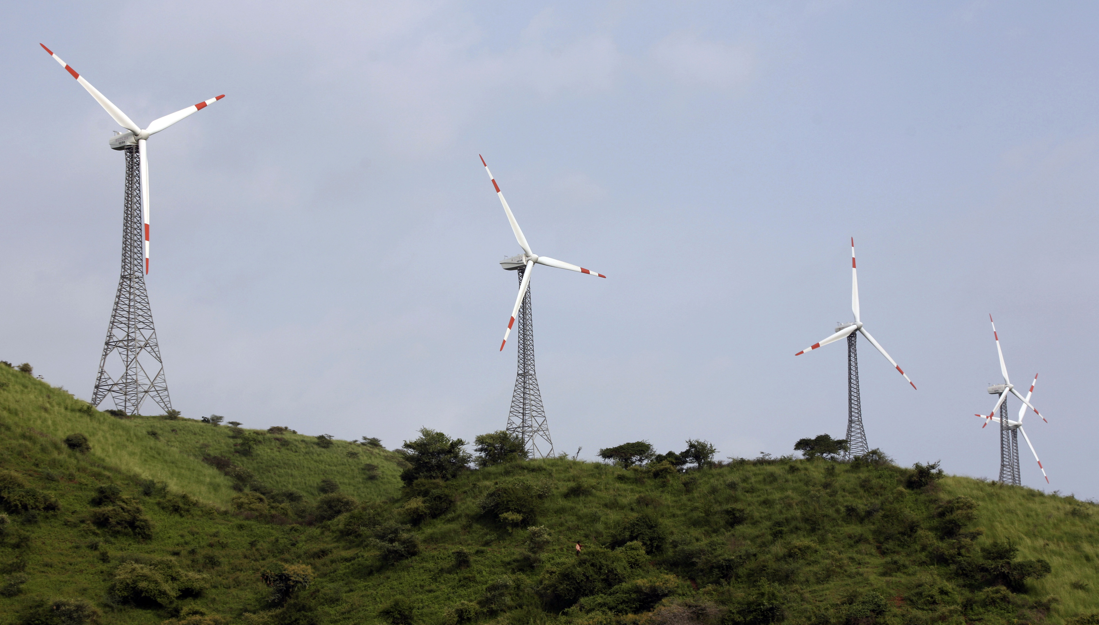 Power-generating windmill turbines are pictured in Suzlon wind farm at Sanodar village, west of the Indian city of Ahmedabad, September 8, 2009.