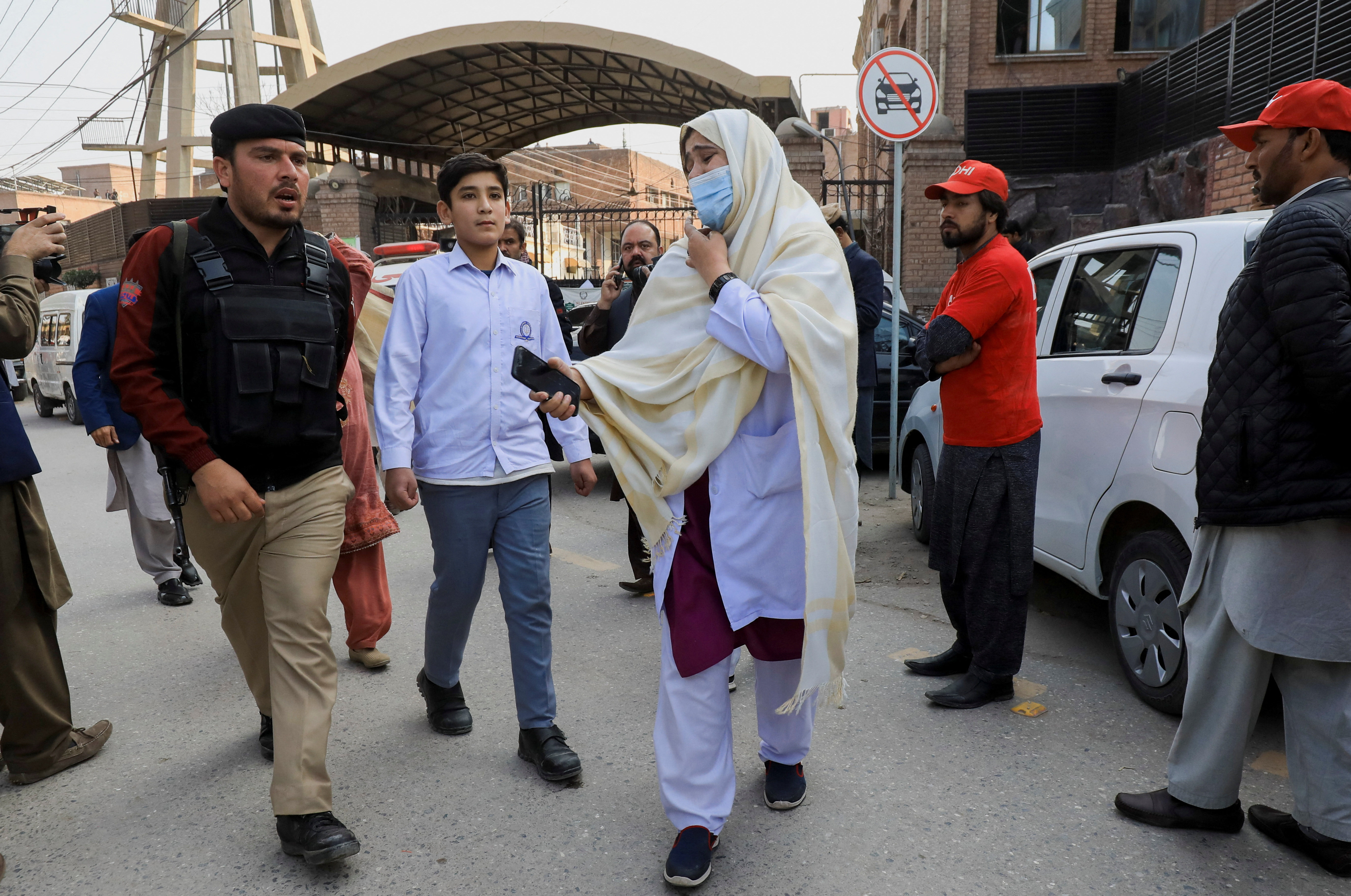 A woman reacts as she searches for her relatives, after a suicide blast in a mosque in Peshawar