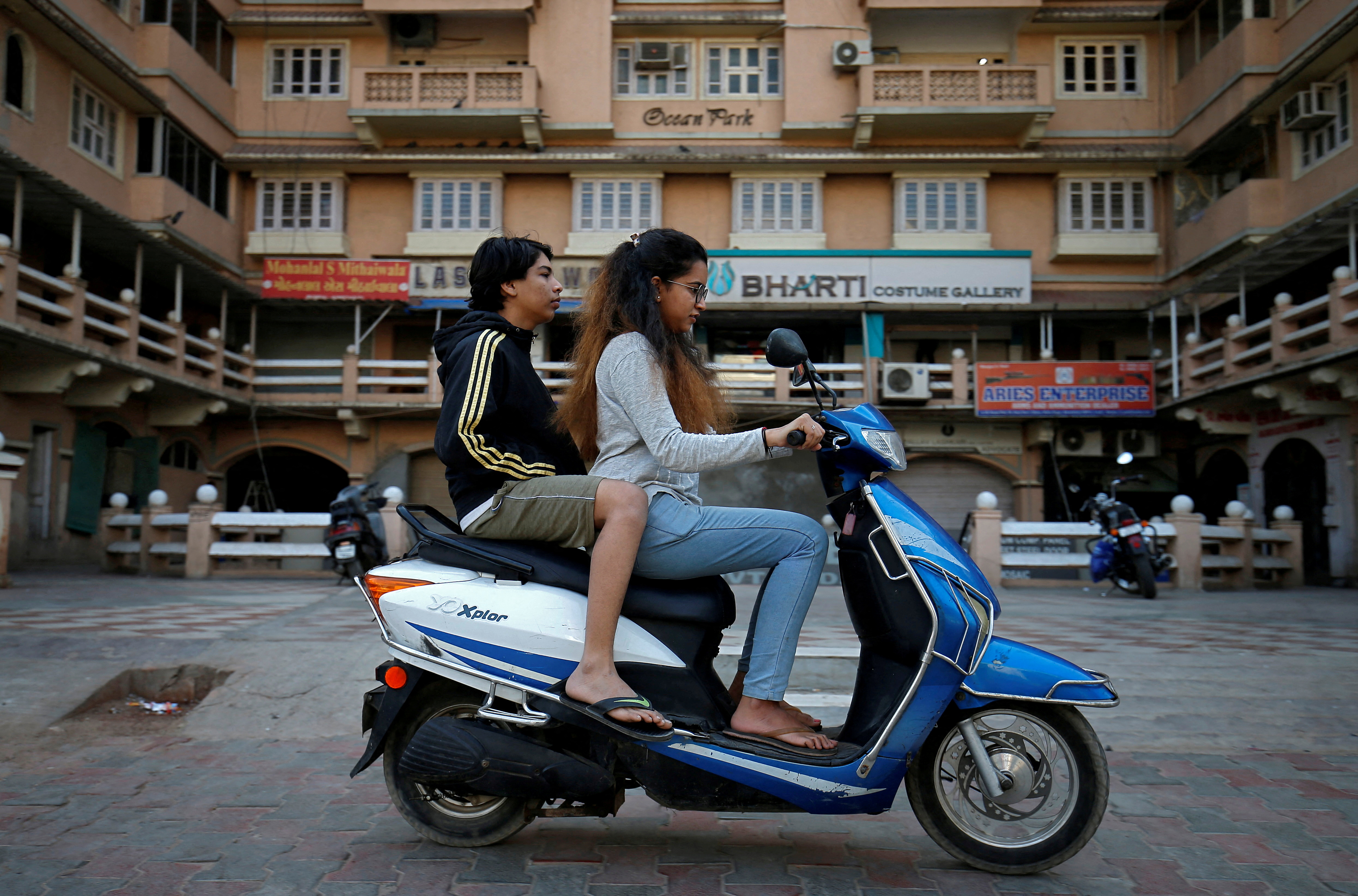 Girls ride an electric scooter in Ahmedabad