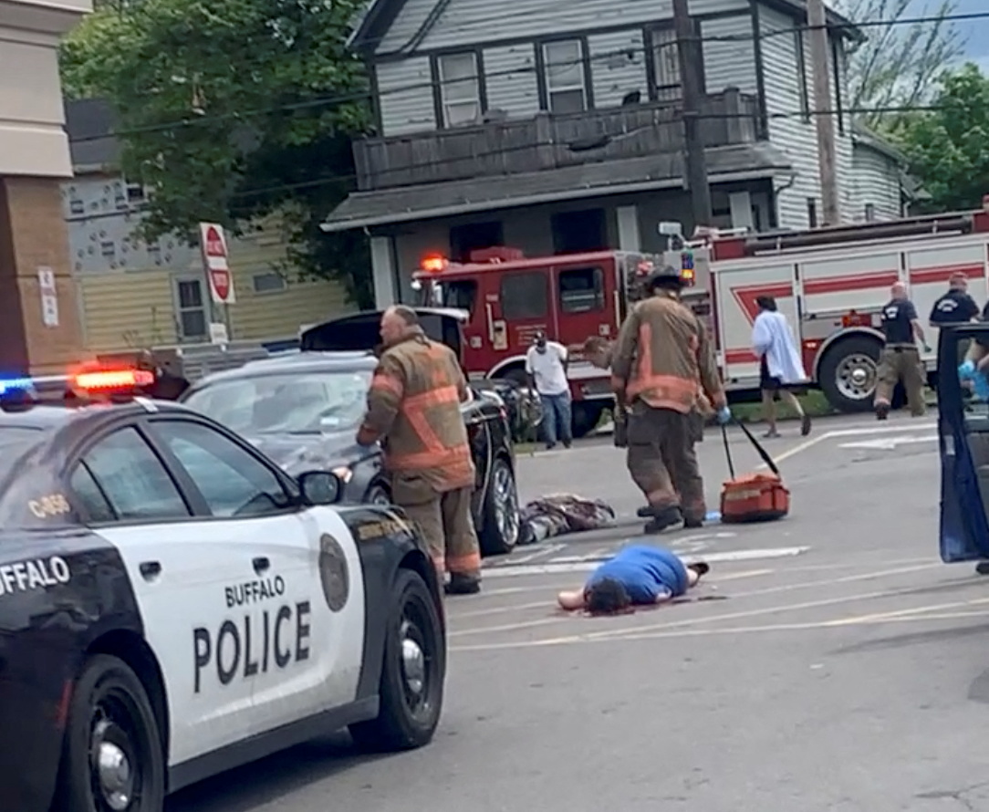 Injured people lie on the ground following a mass shooting in the parking lot of TOPS supermarket, in this still image from a social media video in Buffalo