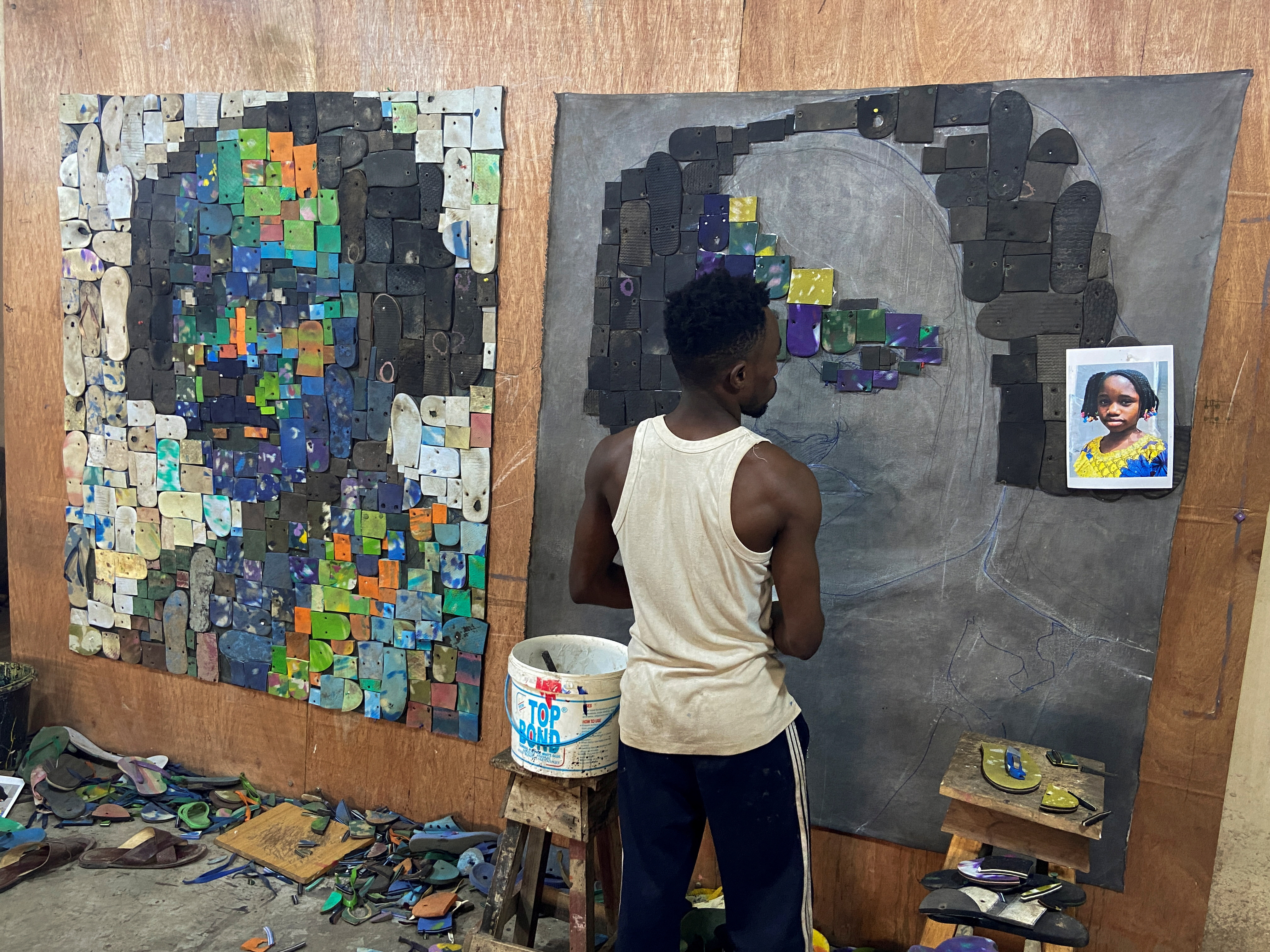 Nigerian artist Eugene Komboye creates artworks using discarded plastic flip-flop sandals in his studio in Abeokuta