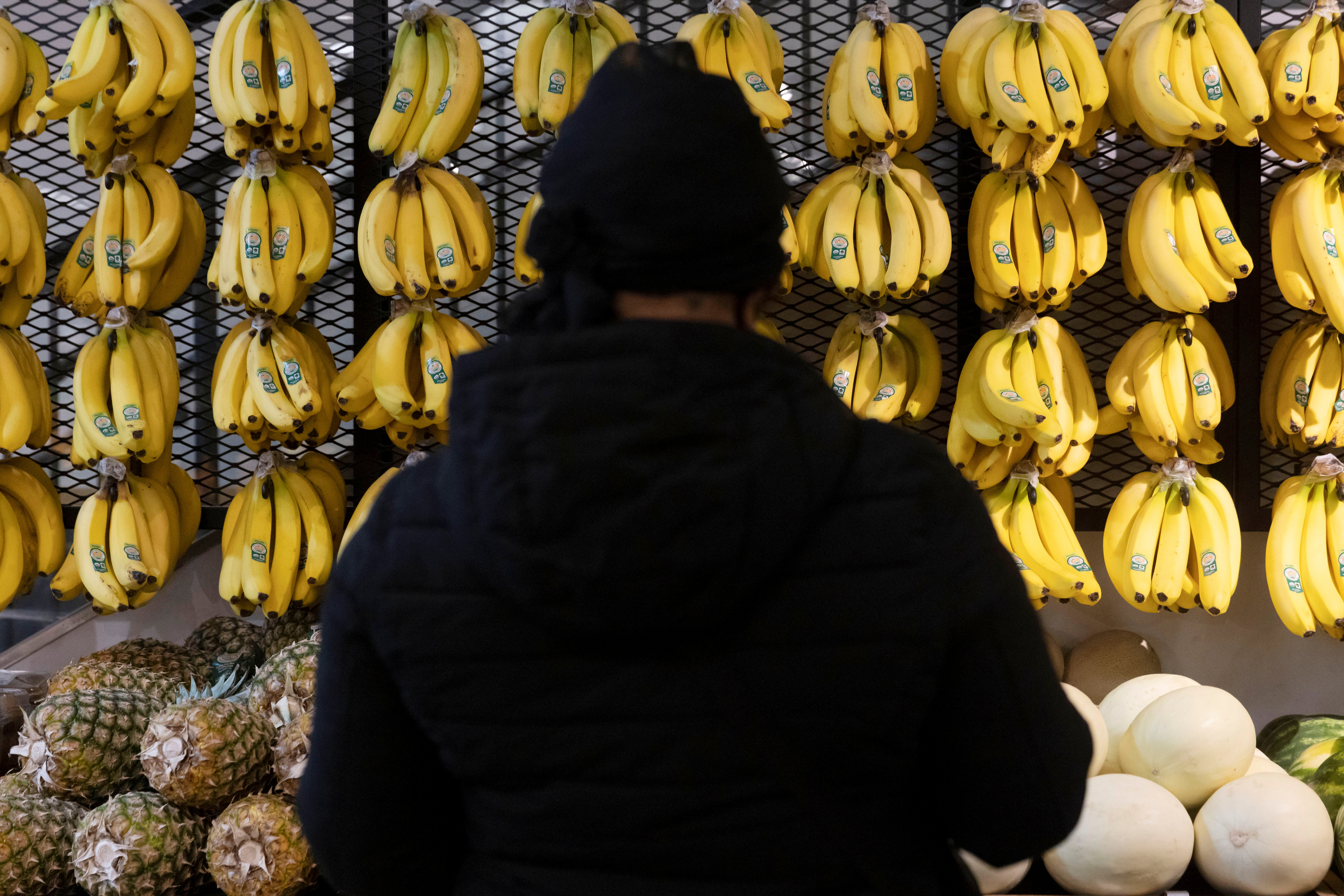 A person shops in a supermarket selling fruit and vegetables in Manhattan, New York City