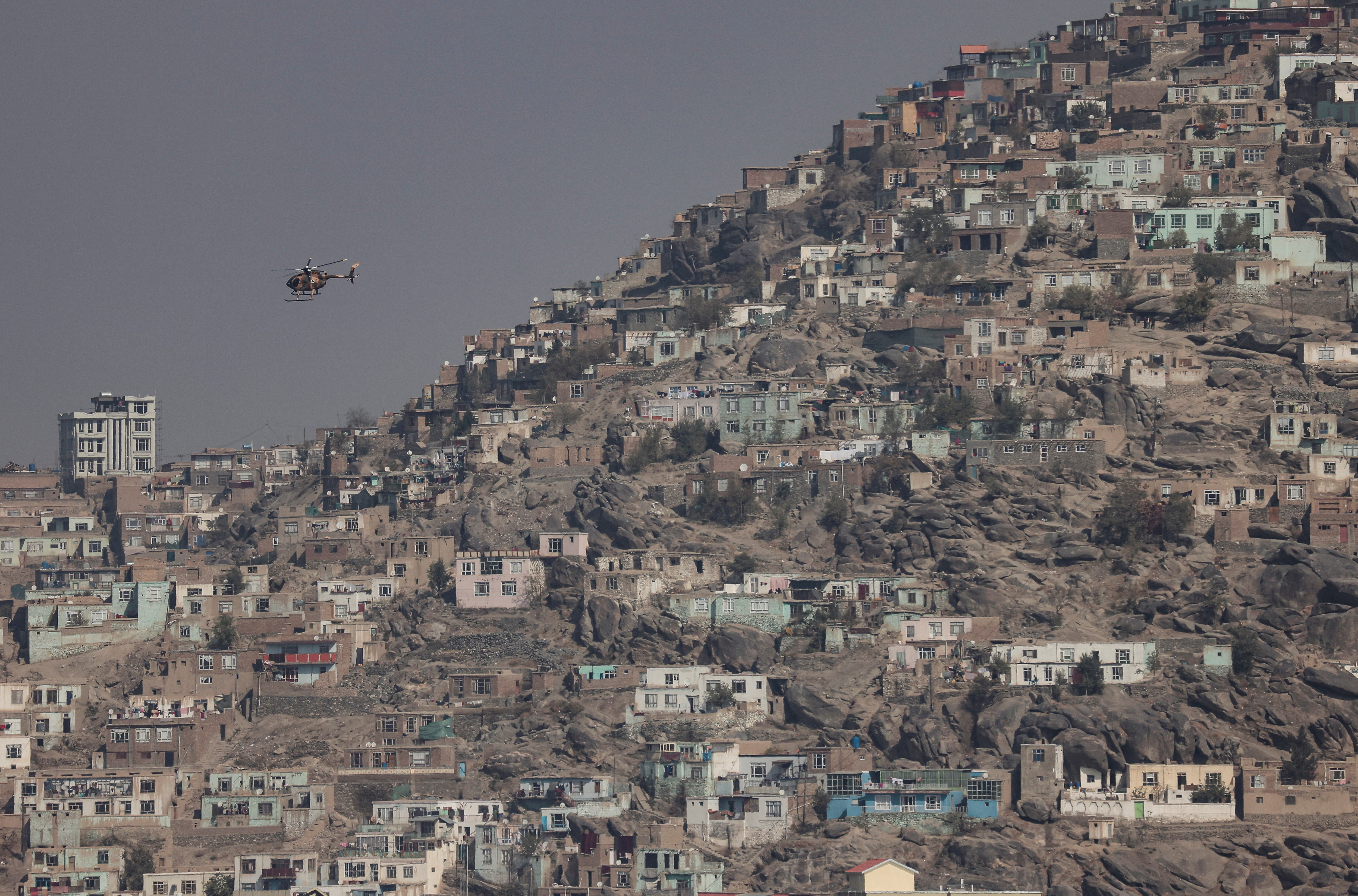 A military helicopter is pictured flying over Kabul,