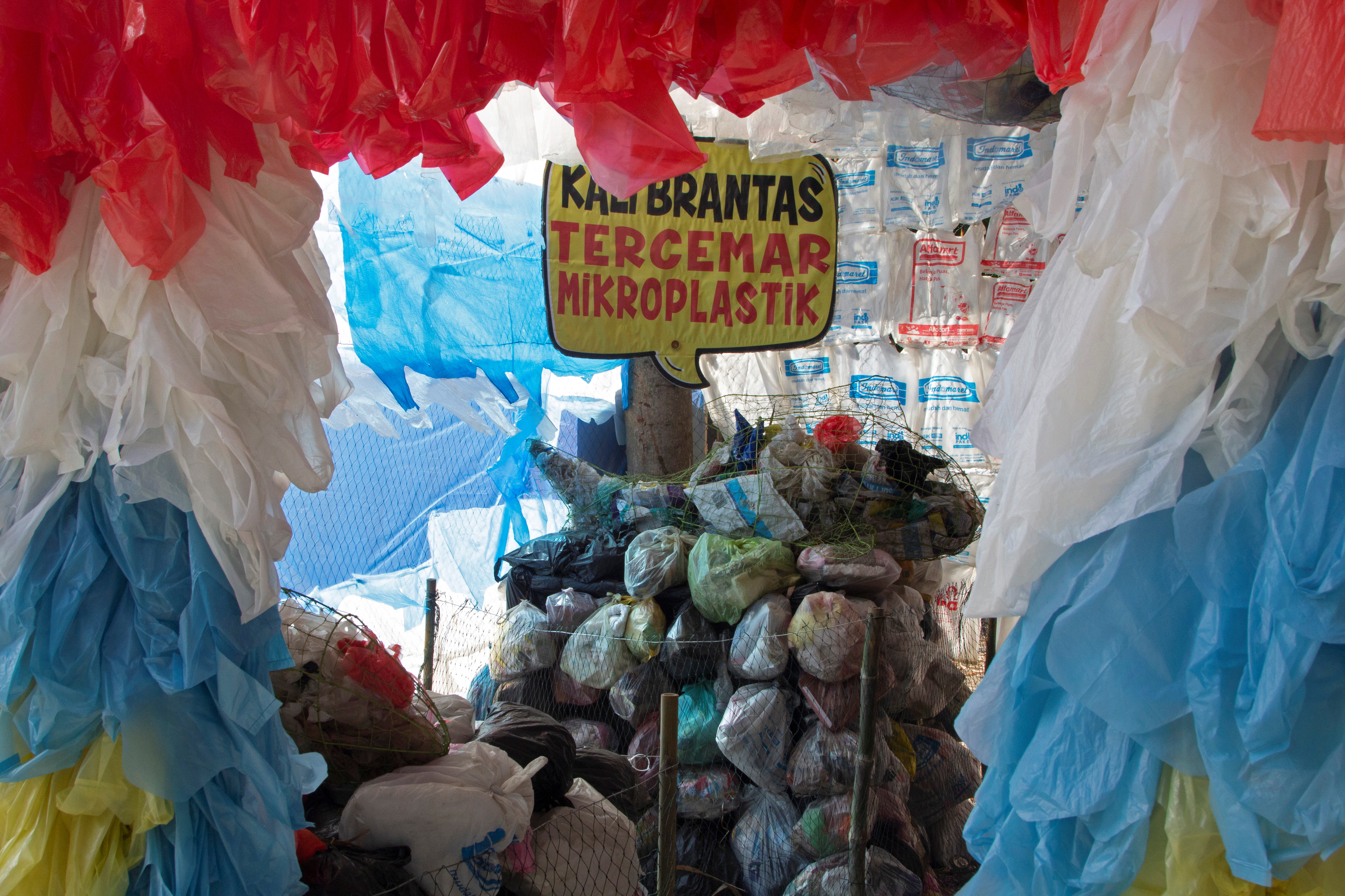 A placard that reads "Brantas river polluted with microplastic," is seen among plastic bags displayed at the plastic museum constructed by Indonesia's environmental activist group Ecological Observation and Wetlands Conservation (ECOTON) in Gresik regency near Surabaya, East Java province, Indonesia, September 28, 2021. Picture taken September 28, 2021. REUTERS/Prasto Wardoyo