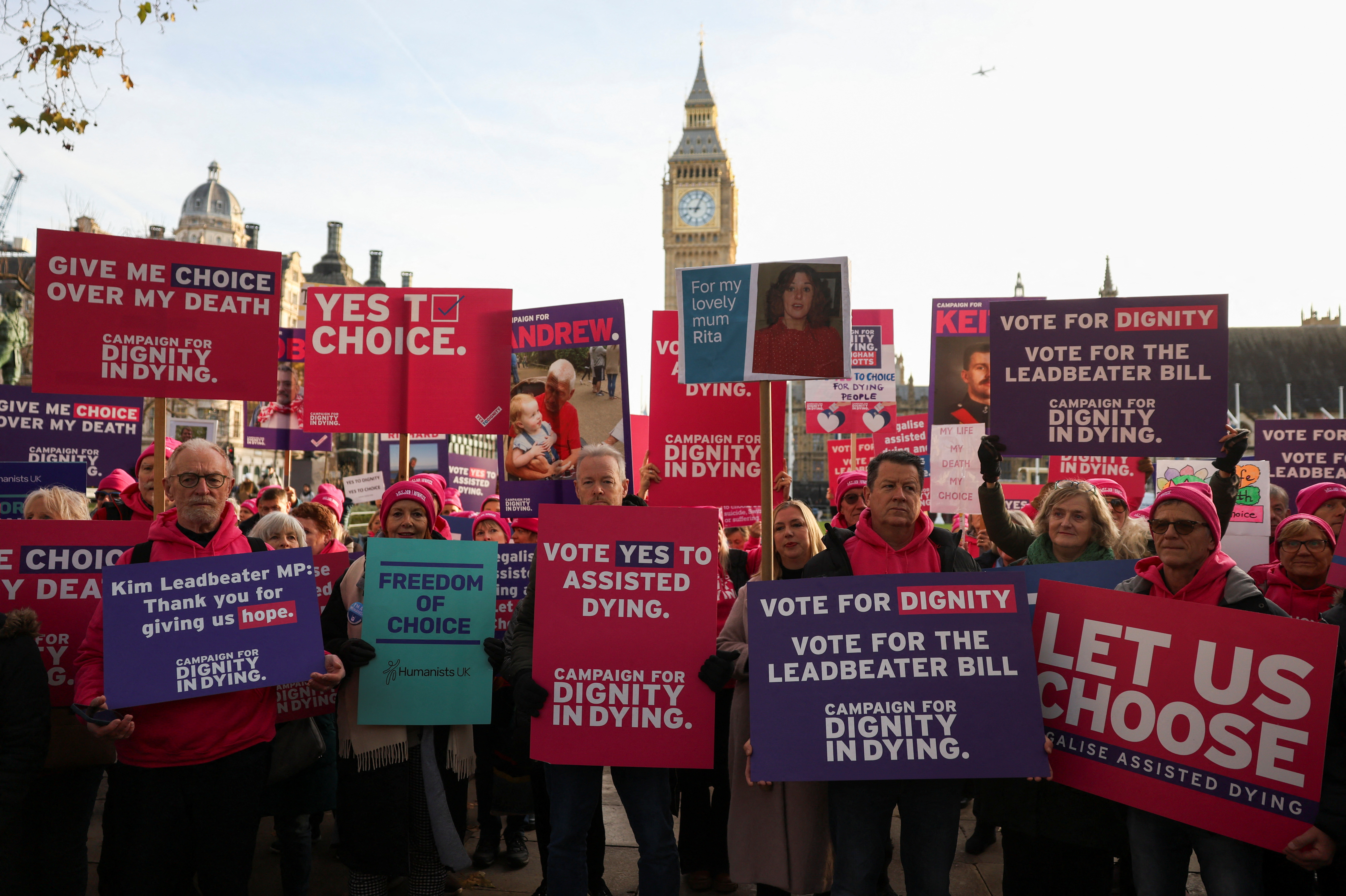 Protestors gather as British lawmakers debate the assisted dying law, in London