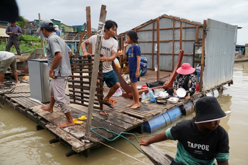 Residents demolish their floating houses on the Tonle Sap river after they were ordered to leave within one week of being notified by local authorities in Prek Pnov district