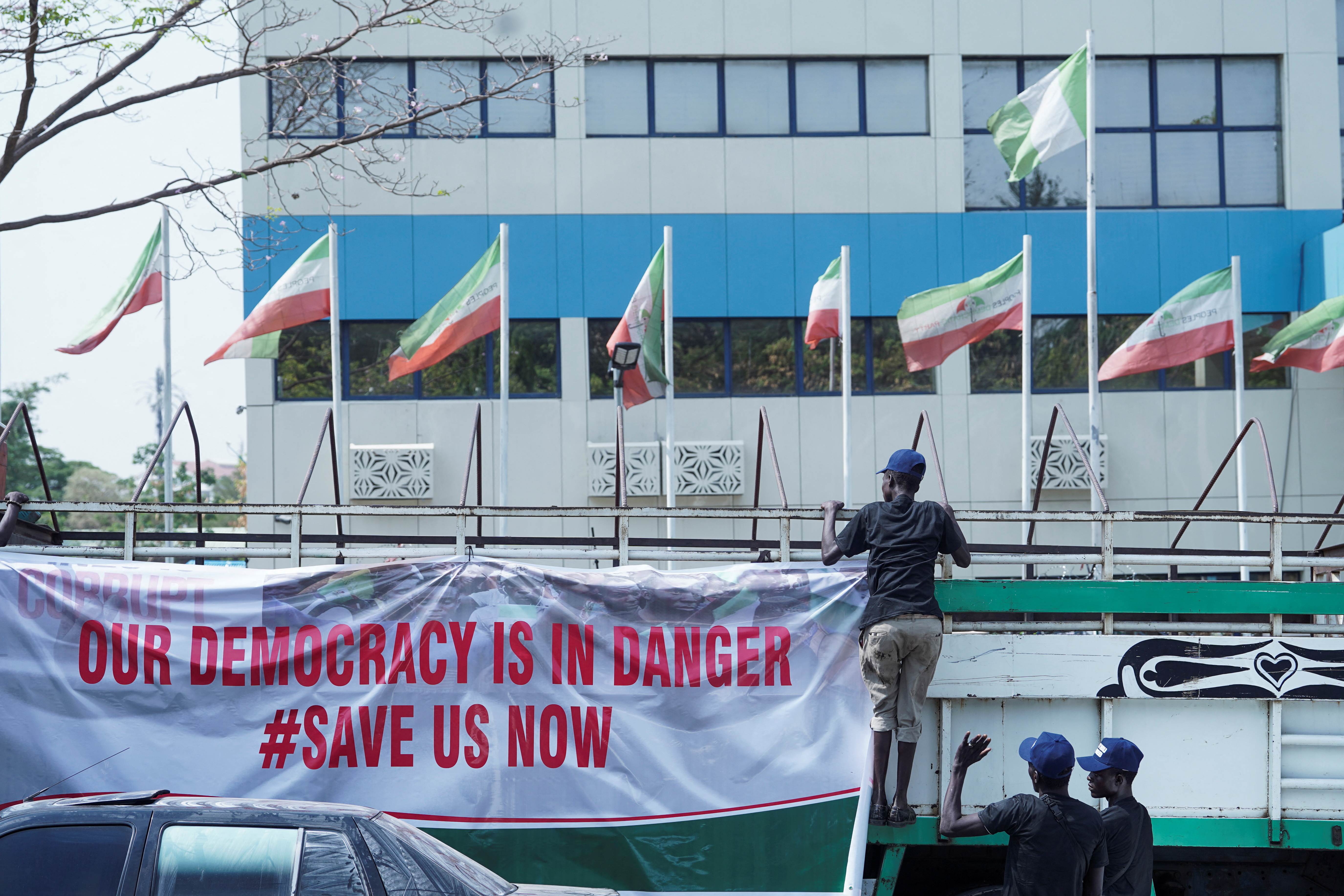 Supporters of the Peoples Democratic Party (PDP) hang protest banner on a truck in front of the Peoples Democratic Party (PDP) secretariat office in Abuja