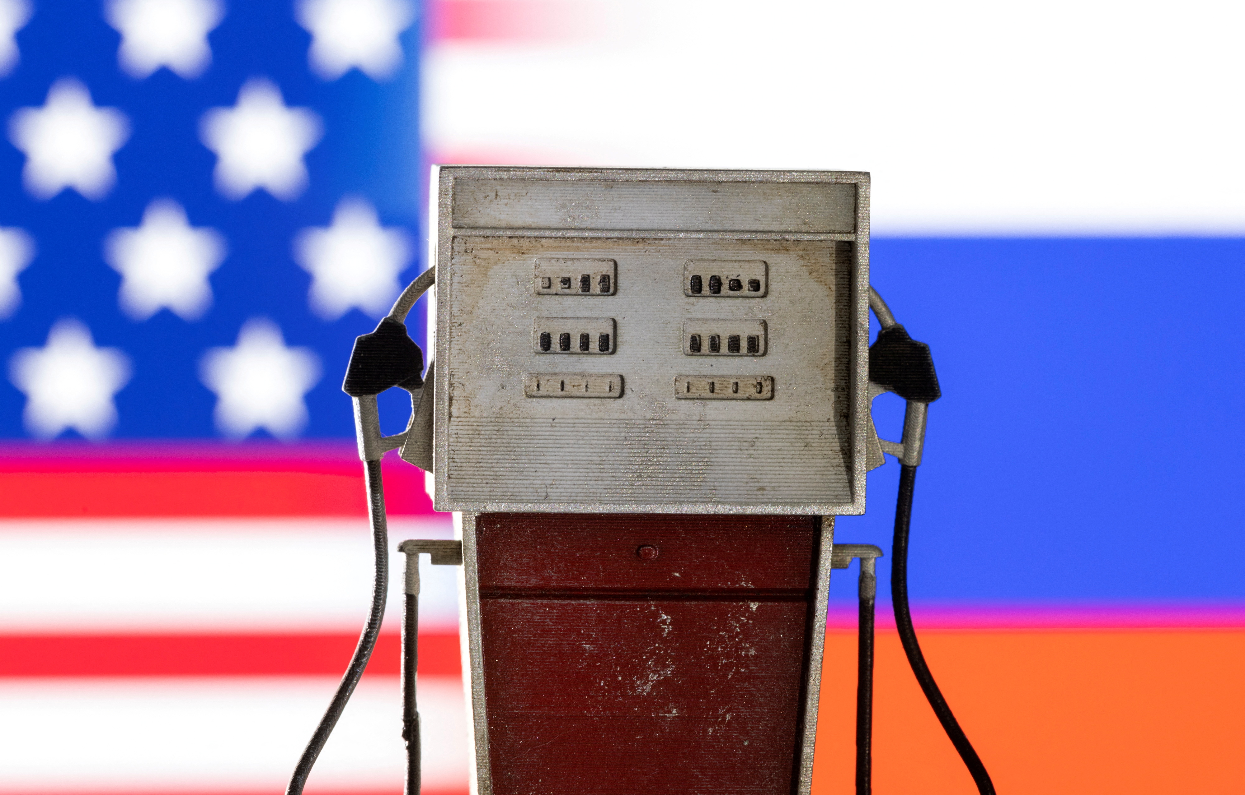 Illustration shows model of petrol pump, U.S. and Russian flag colors