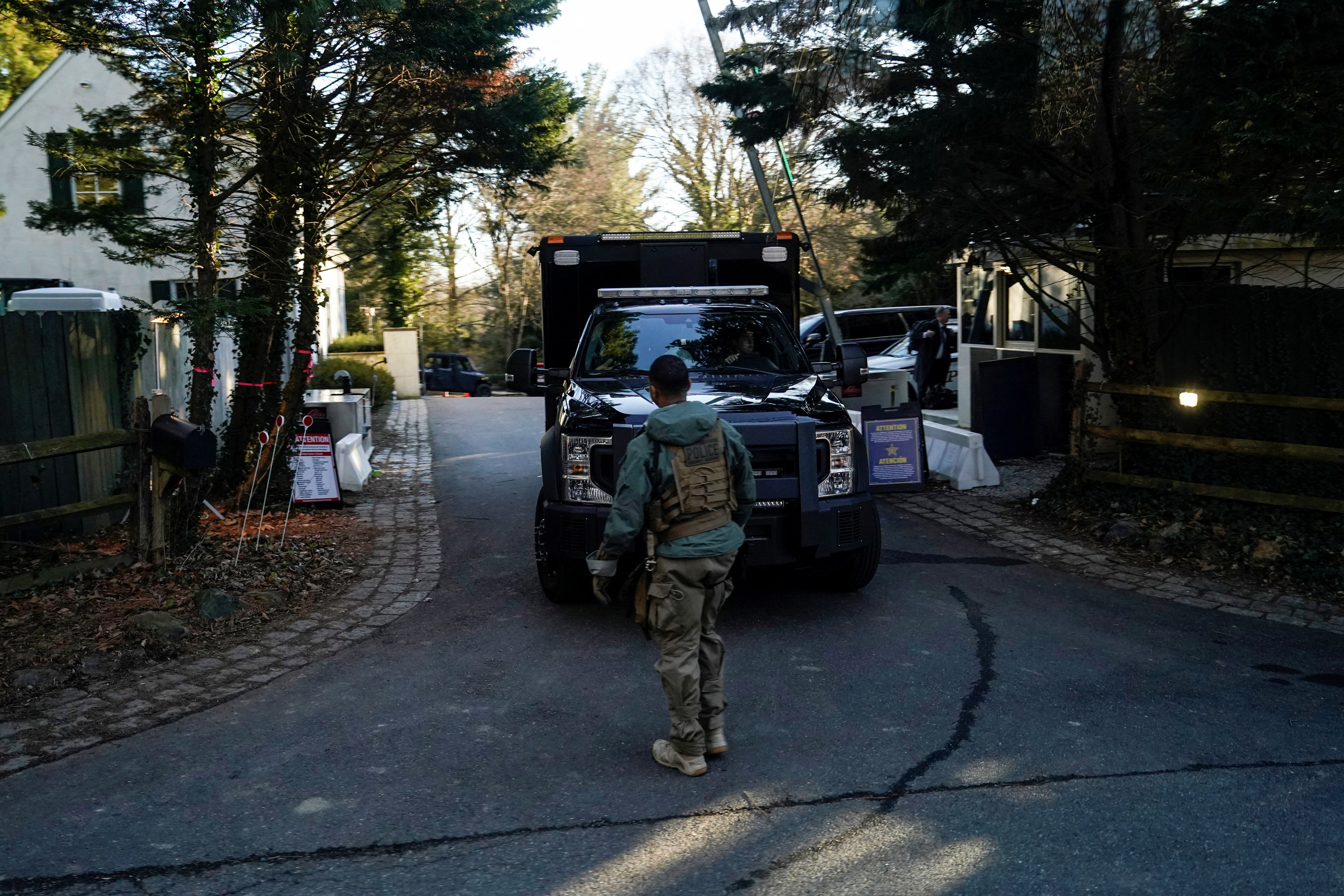 Secret Service personnel park vehicles in the driveway leading to U.S. President Joe Biden's house in Wlimington, Delaware