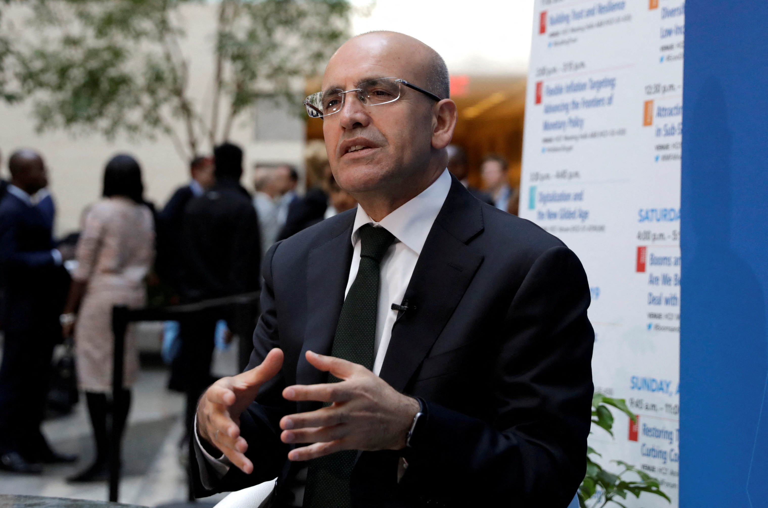 Turkish Deputy Prime Minister Mehmet Simsek speaks during a television interview after IMFC plenary the IMF/World Bank spring meeting in Washington
