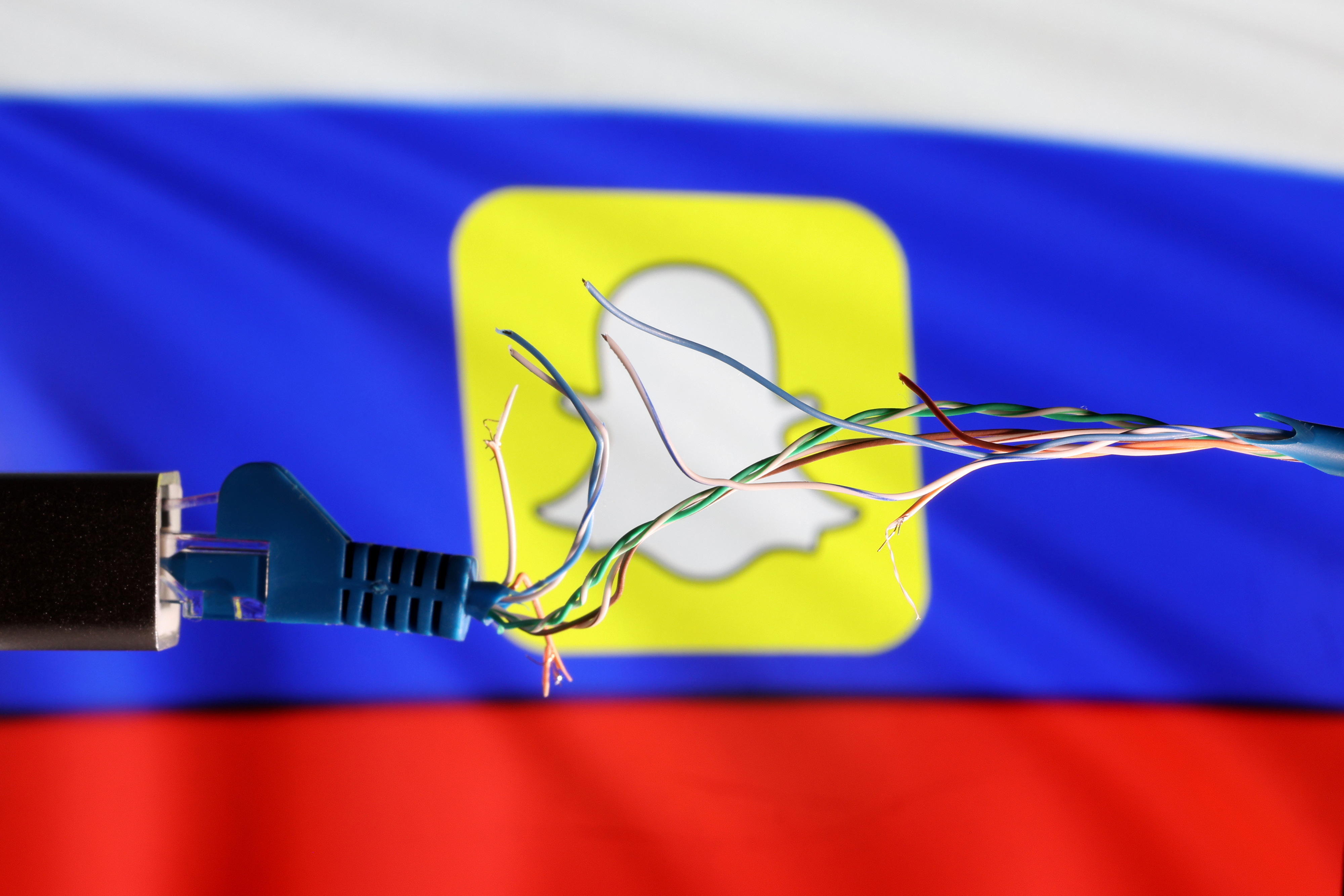 Illustration shows Broken Ethernet cable, Russian flag and SnapChat logo