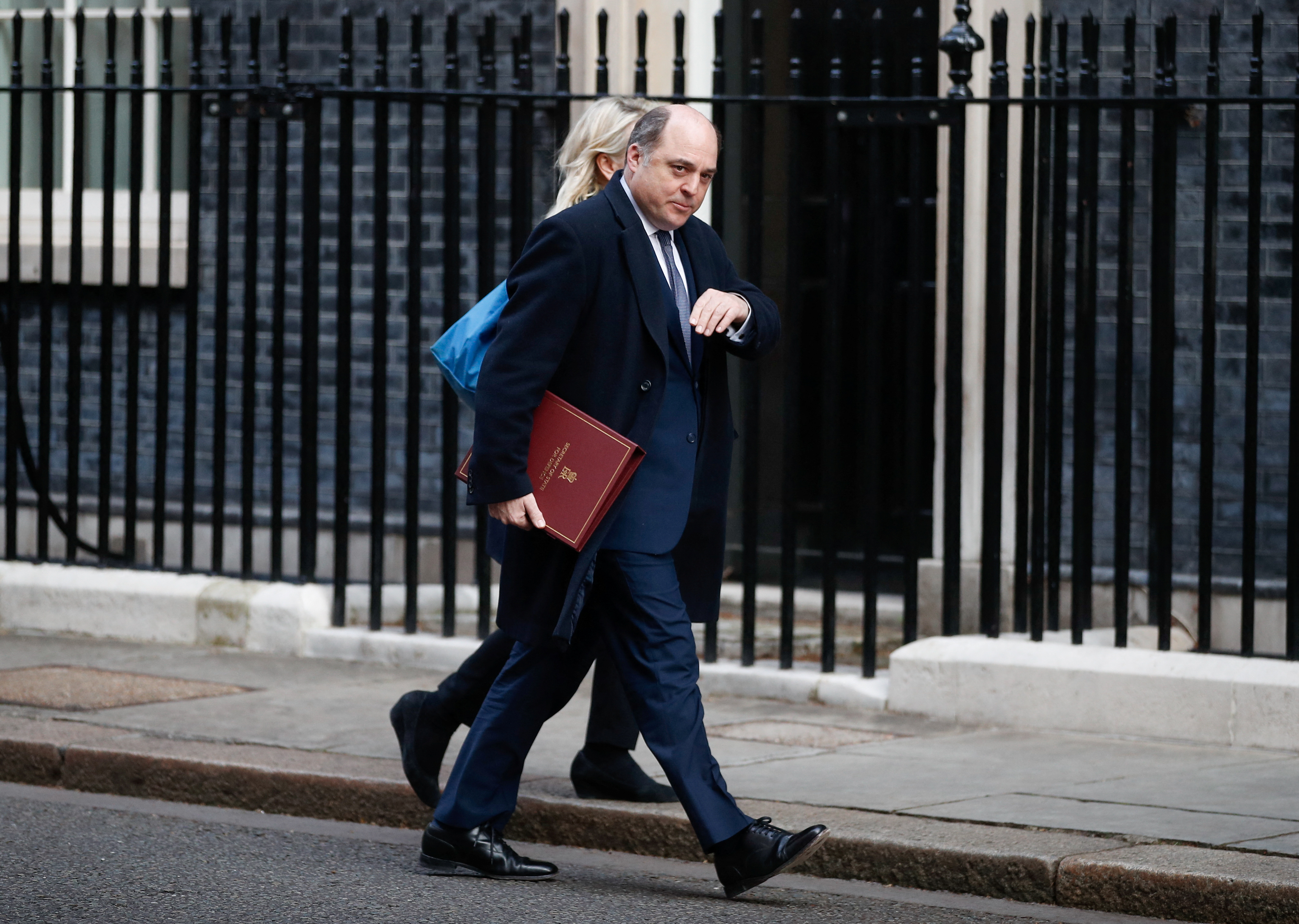 British Defence Secretary Ben Wallace walks outside Downing Street, in London