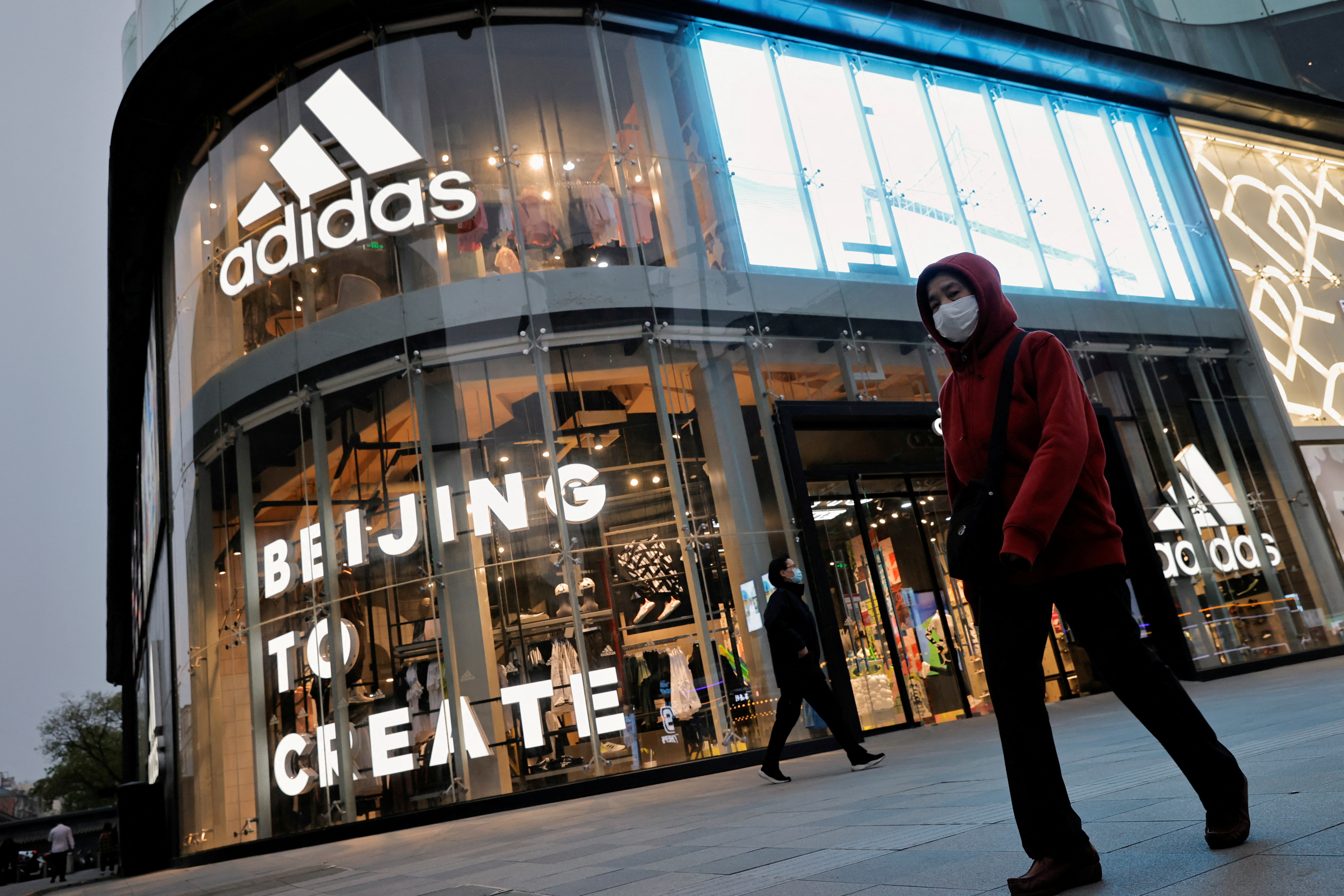 People walk past an Adidas store in Beijing, China,