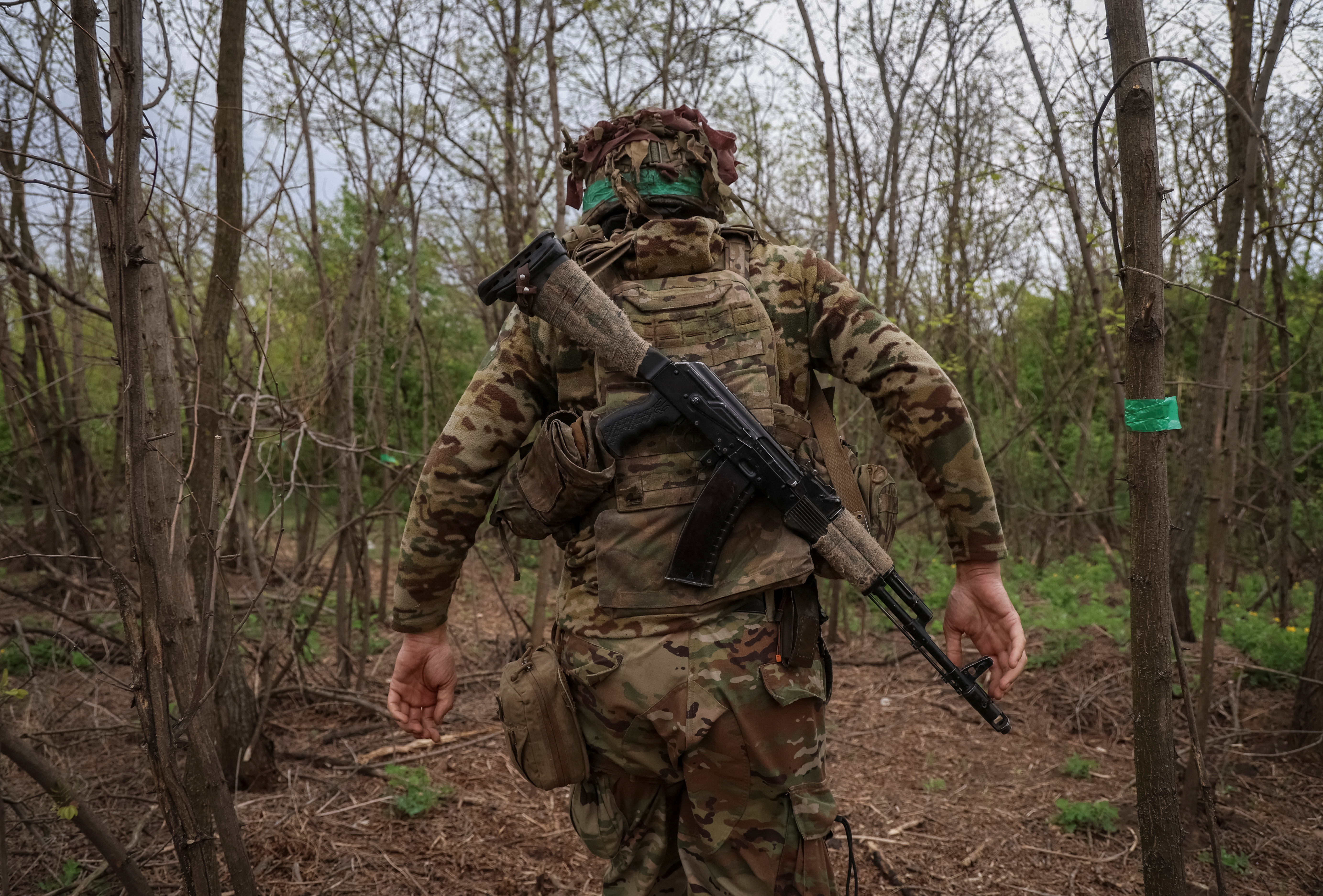 A Ukrainian serviceman walks at a front line