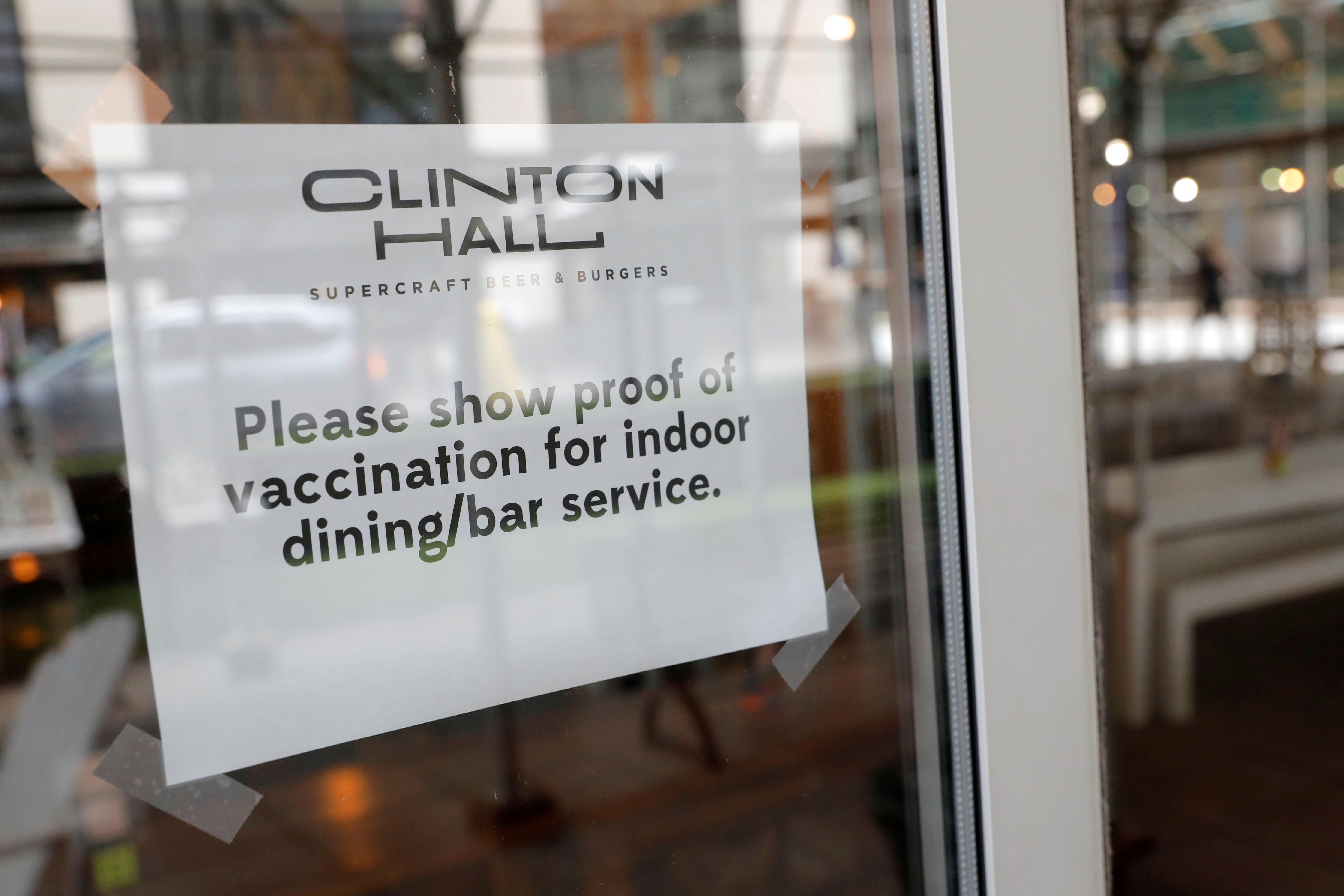 Signage is seen on a window in a restaurant as the vaccine mandate commenced during the outbreak of the coronavirus disease (COVID-19) in Manhattan, New York City