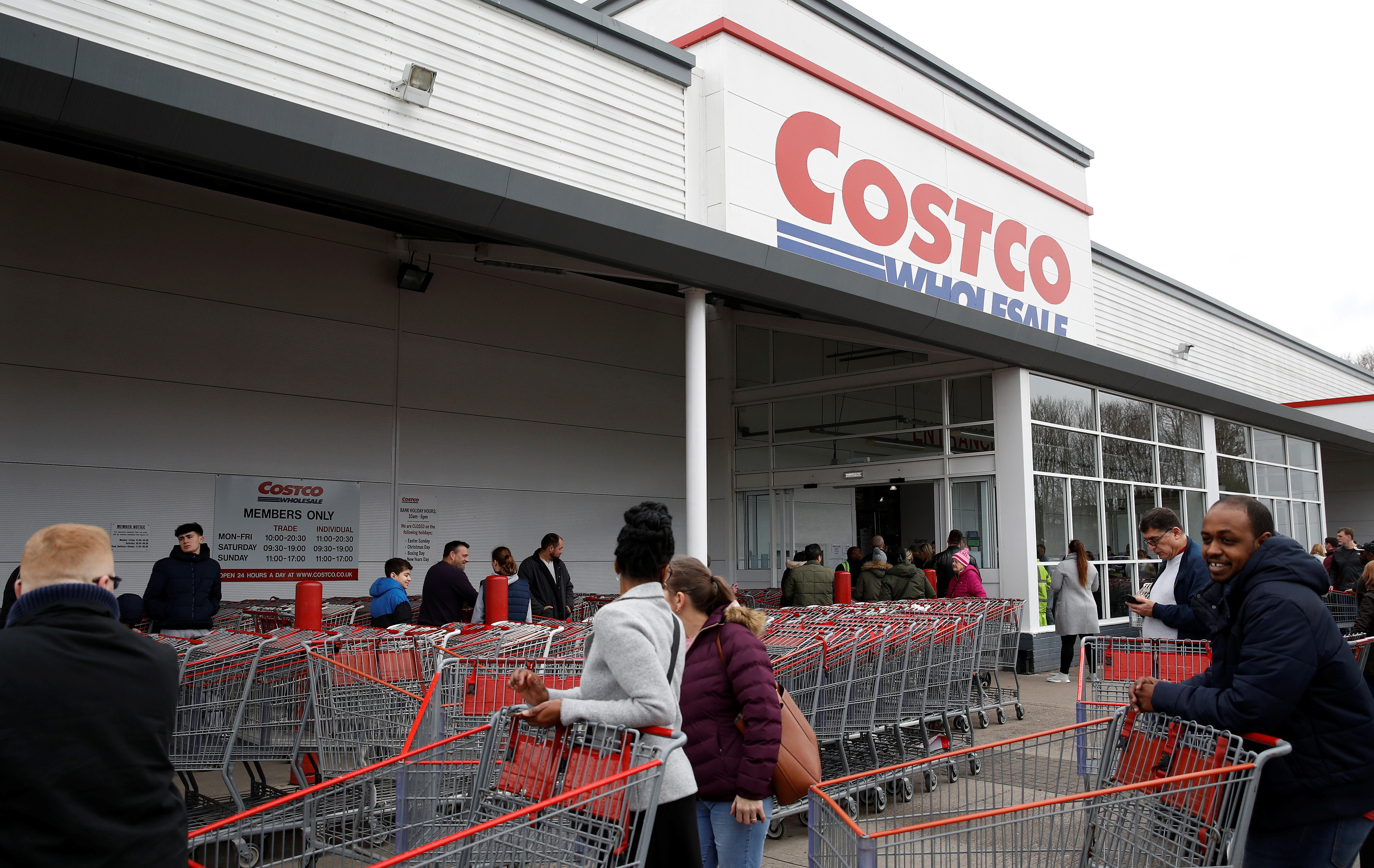 People form a long queue as they wait for the Costco wholesalers to open in Manchester, Britain