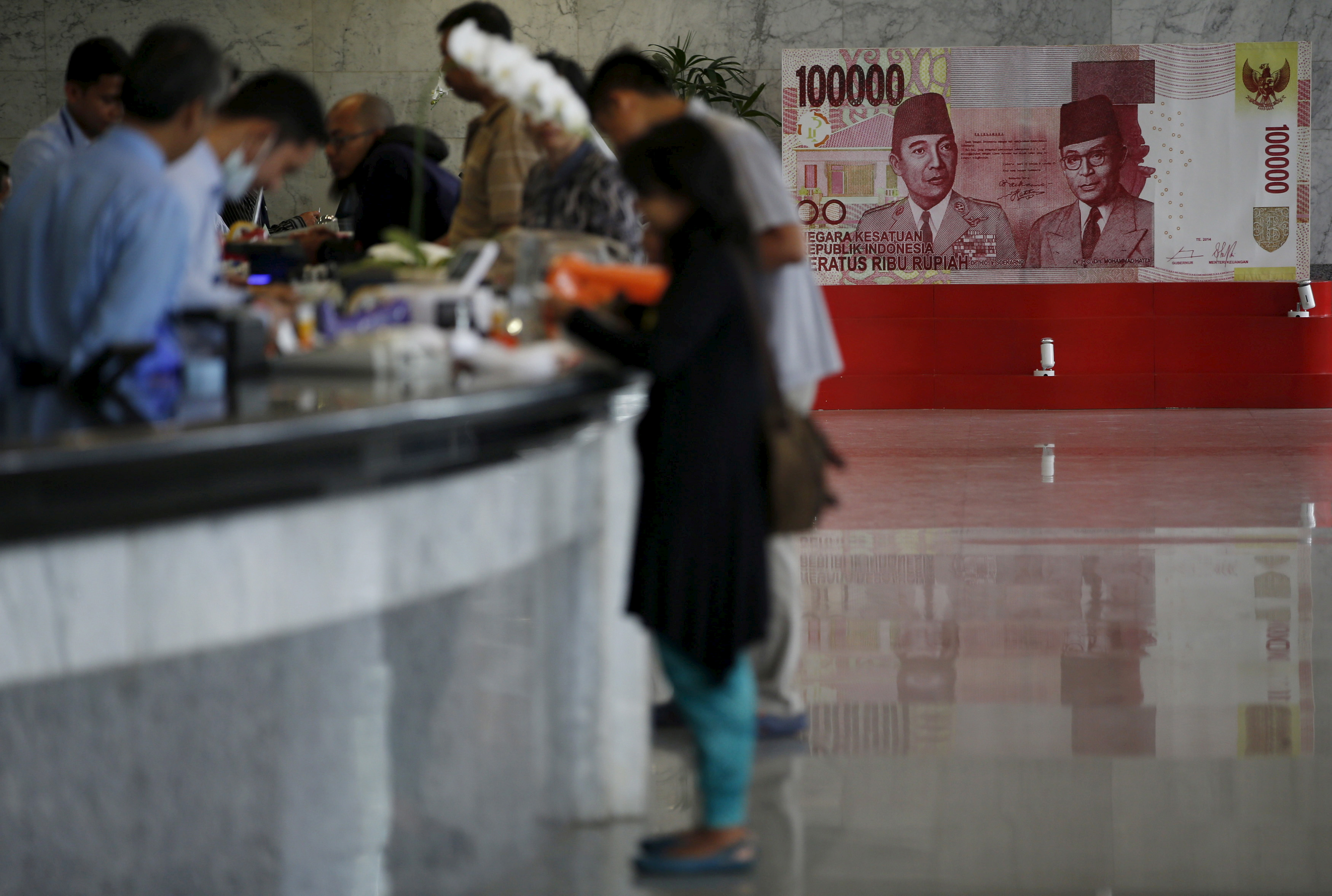 Customers are seen at a counter inside the Bank Indonesia complex in Jakarta