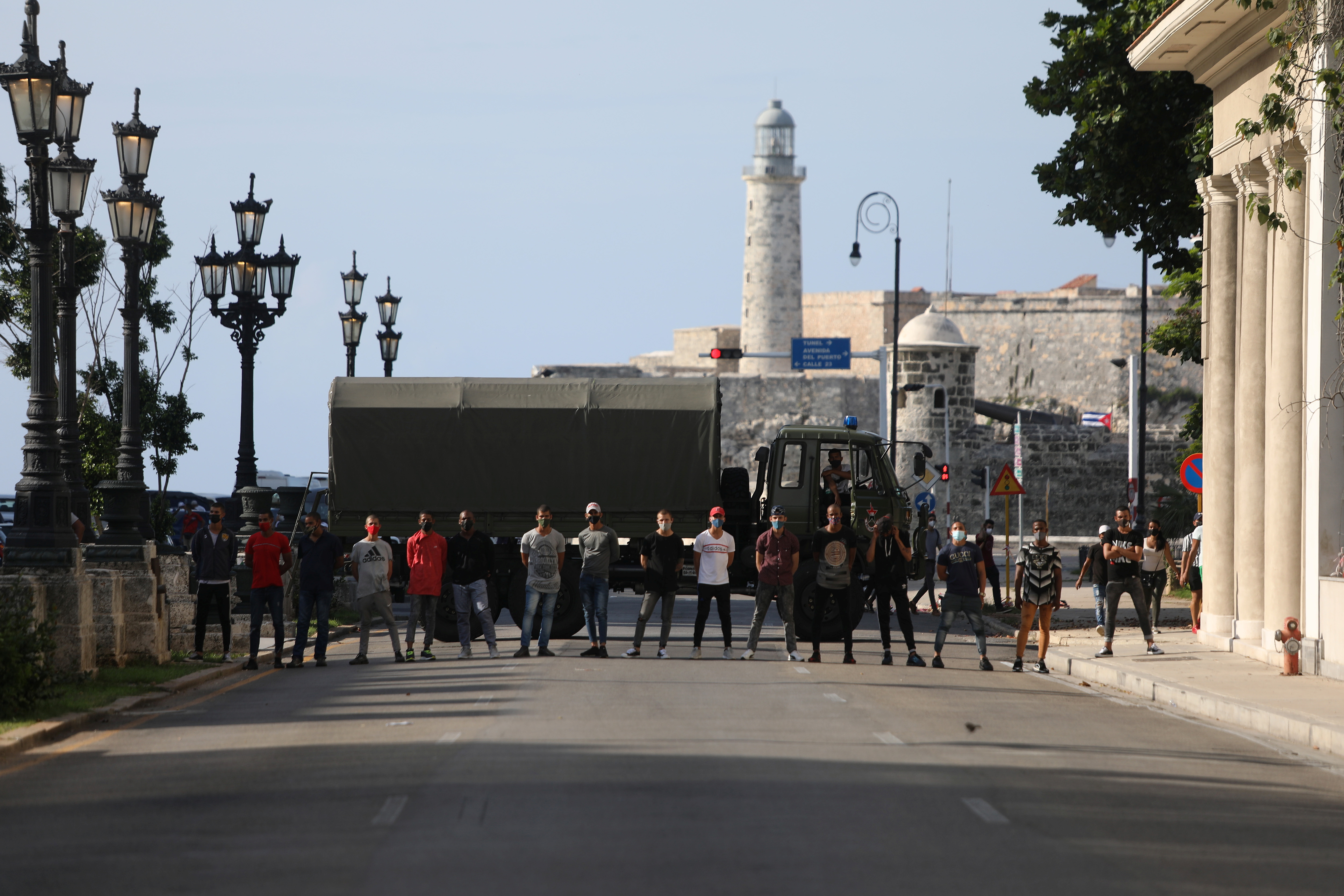 Plain clothes police block a road during a protest against and in support of the government in Havana