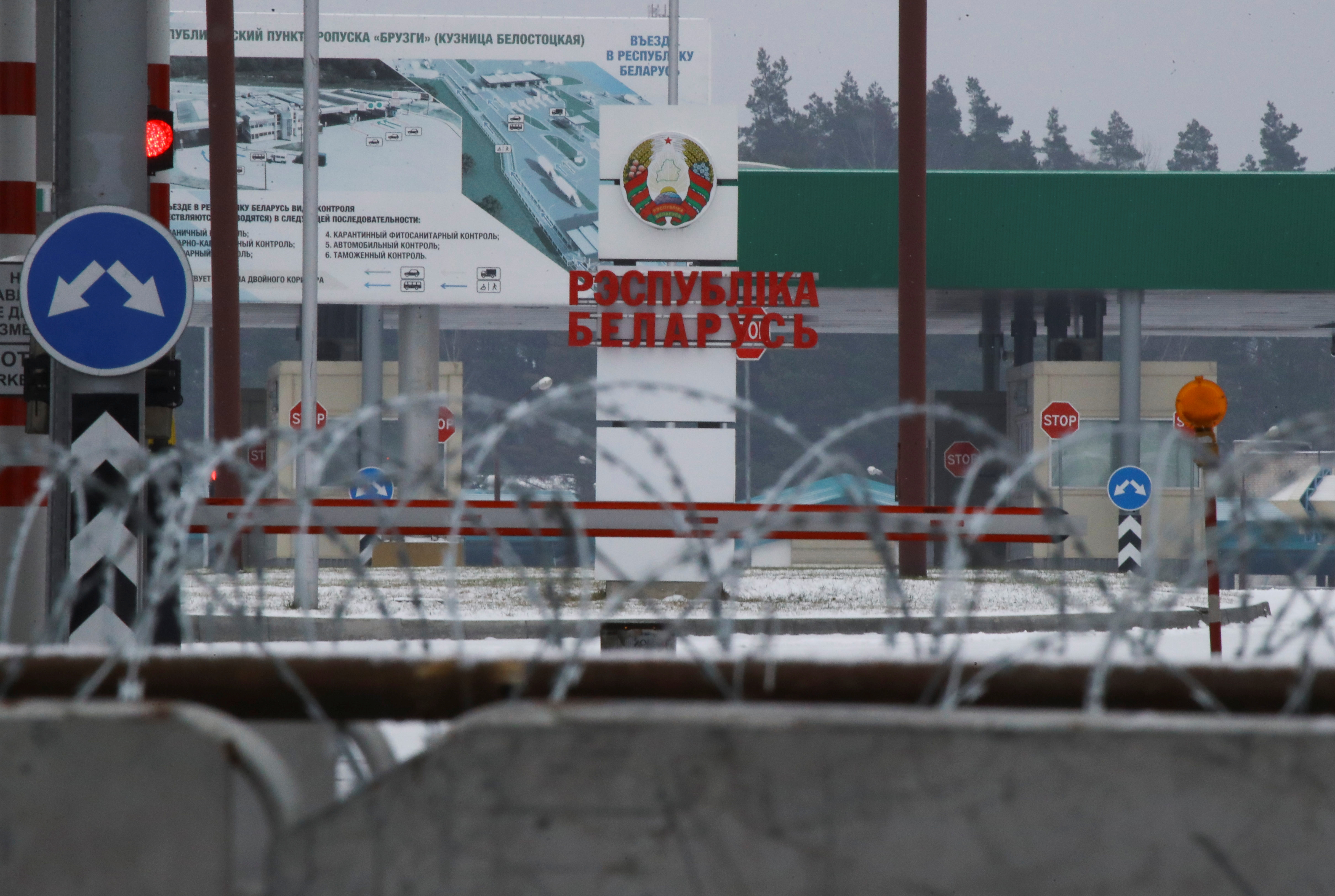 A Belarusian sign is seen at the Kuznica-Bruzgi checkpoint on the Polish-Belarusian border amid the migrant crisis, as seen from Kuznica, Poland, December 6, 2021. REUTERS/Kacper Pempel