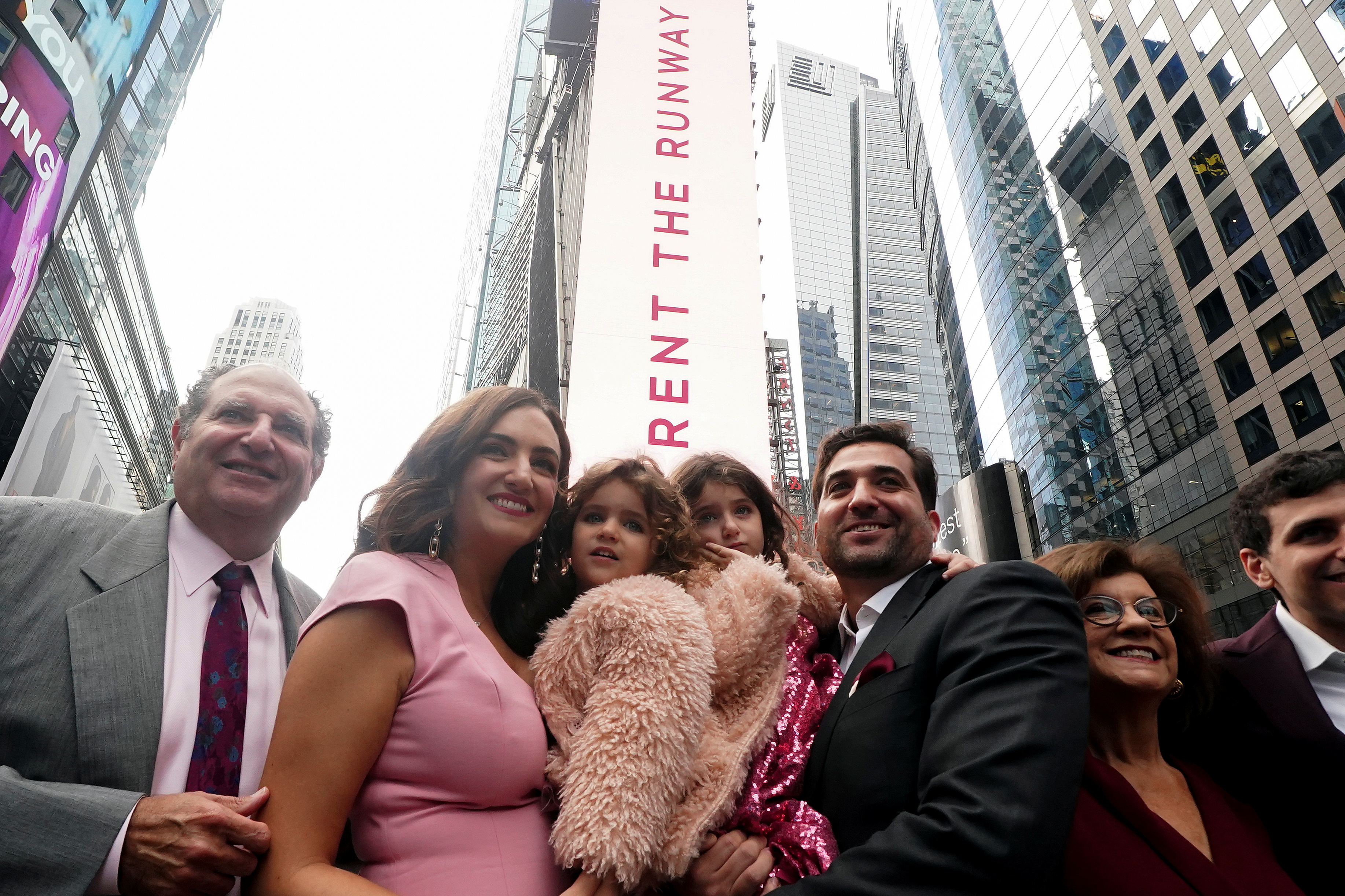 CEO of Rent the Runway Jennifer Hyman, husband Benjamin Stauffer and their children Aurora and Selene pose for photos after their IPO on the NASDAQ exchange in Times Square in the Manhattan borough of New York City, New York, U.S., October 27, 2021.  REUTERS/Carlo Allegri