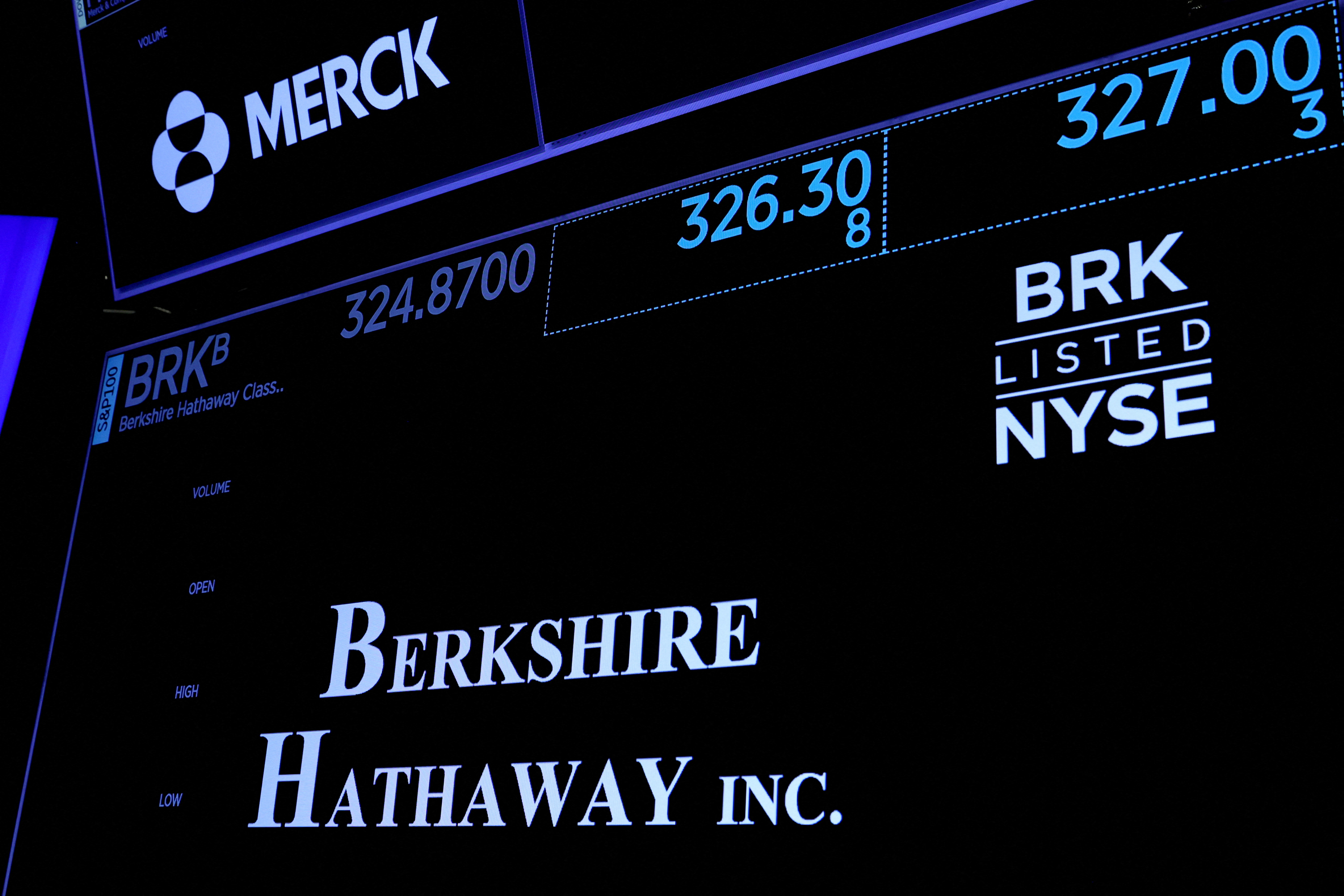 Trading information and logo for Berkshire Hathaway is displayed on a screen on the floor of the NYSE in New York