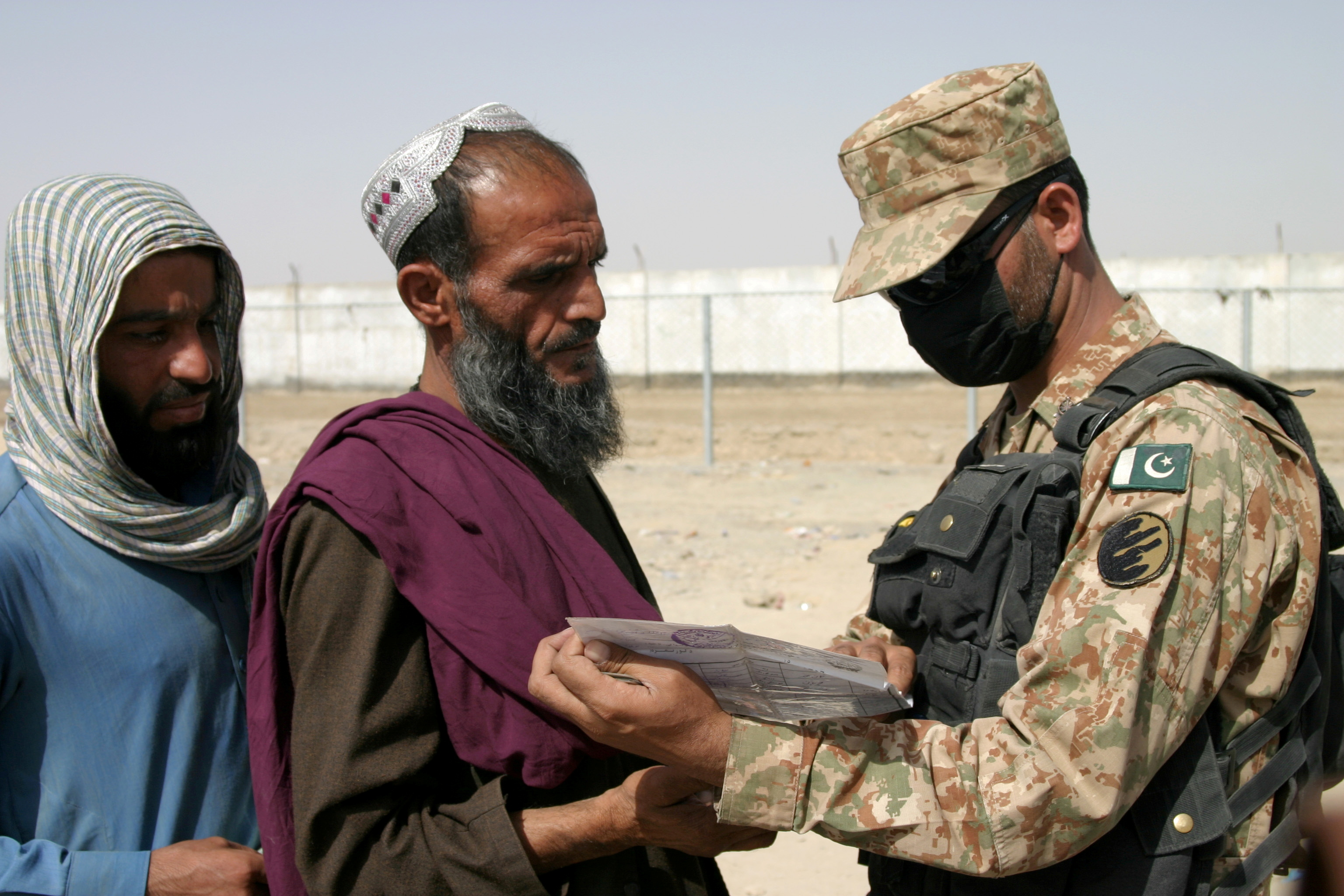 A Pakistani worker  checks documents of radical   arriving from Afghanistan astatine  the Friendship Gate crossing constituent   successful  the Pakistan-Afghanistan borderline  municipality  of Chaman, Pakistan August 27, 2021. REUTERS/Saeed Ali Achakzai/File Photo