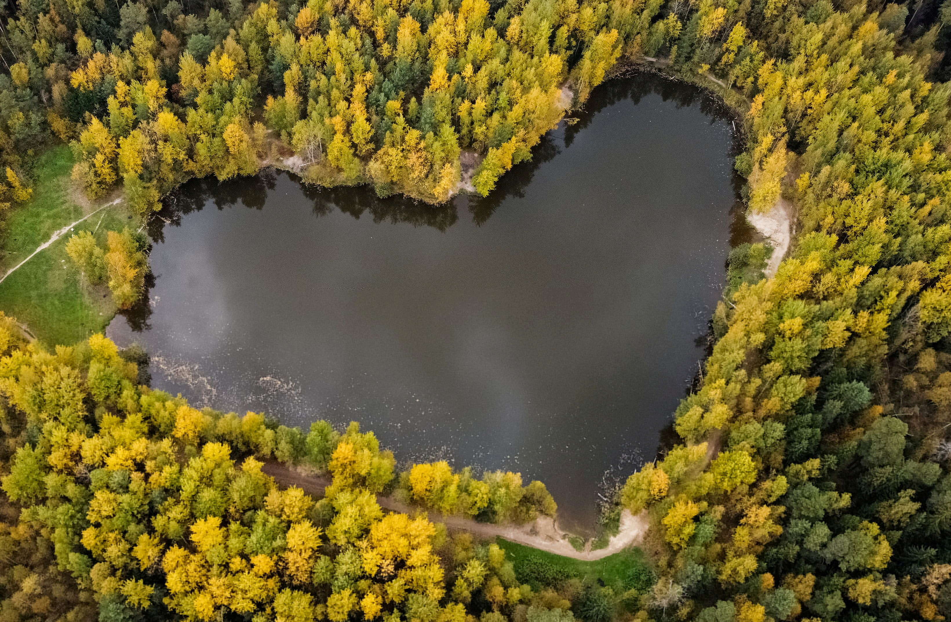 A lake in a shape of a heart is seen surrounded by autumn-coloured trees outside Balashikha