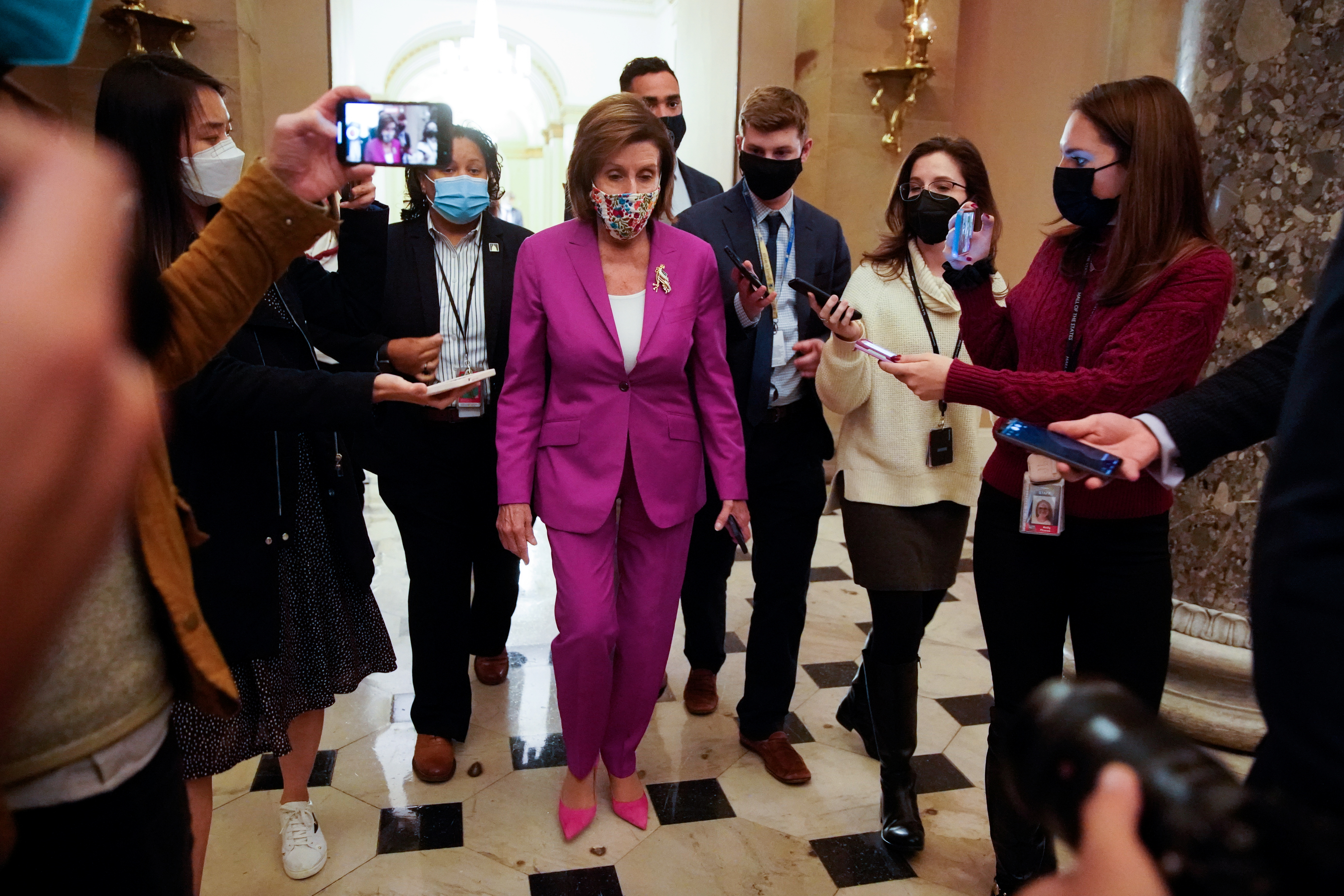 House Speaker Nancy Pelosi (D-CA) is pursued by reporters after the House passed the bipartisan infrastructure package at the U.S. Capitol in Washington, U.S., November 6, 2021. REUTERS/Elizabeth Frantz