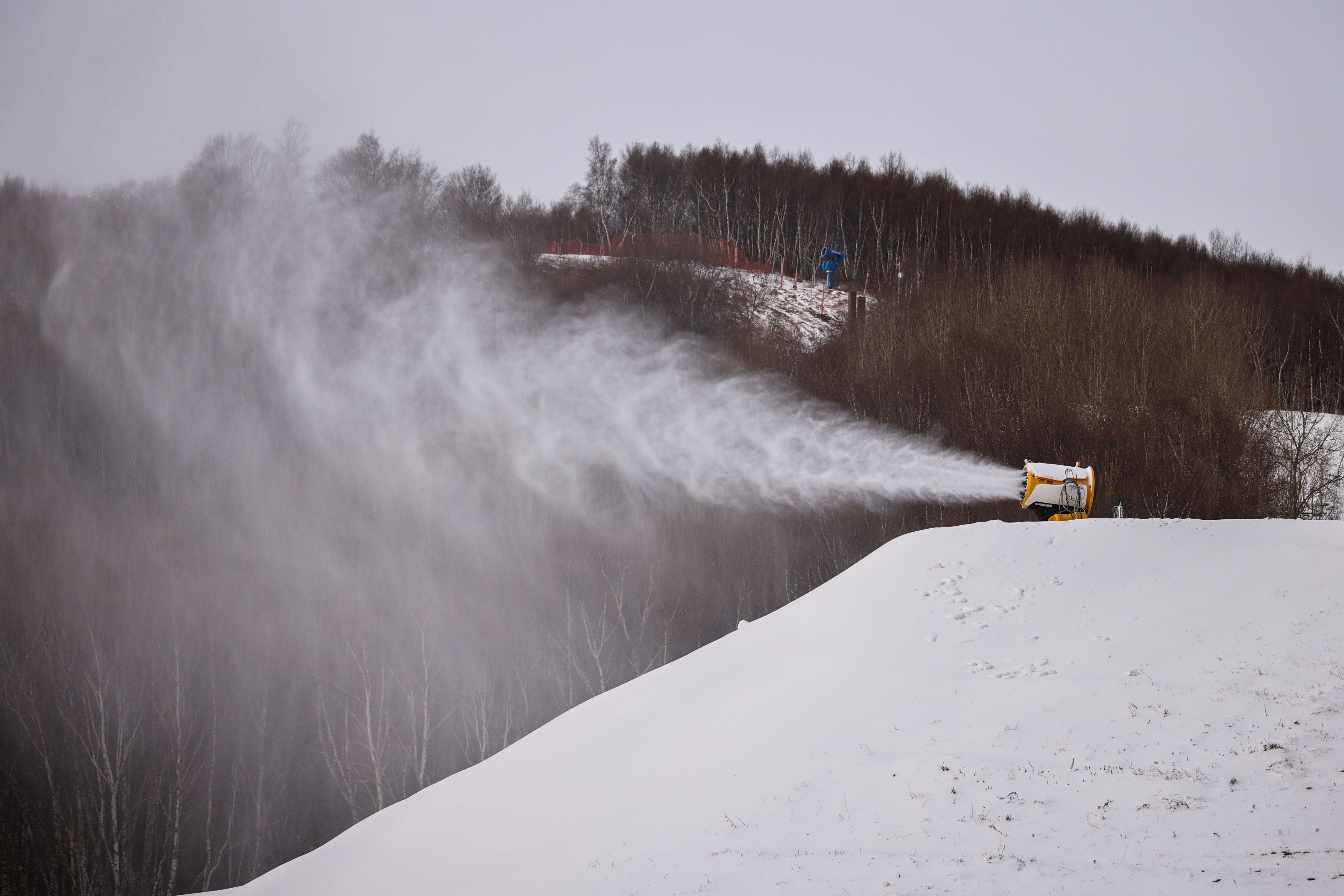 A TechnoAlpin snow gun sprays snow onto a slope for recreational use at the Genting ski resort in Zhangjiakou near venues of the Beijing 2022 Winter Olympics, Hebei province, China, November 20, 2021. REUTERS/Thomas Peter/File Photo