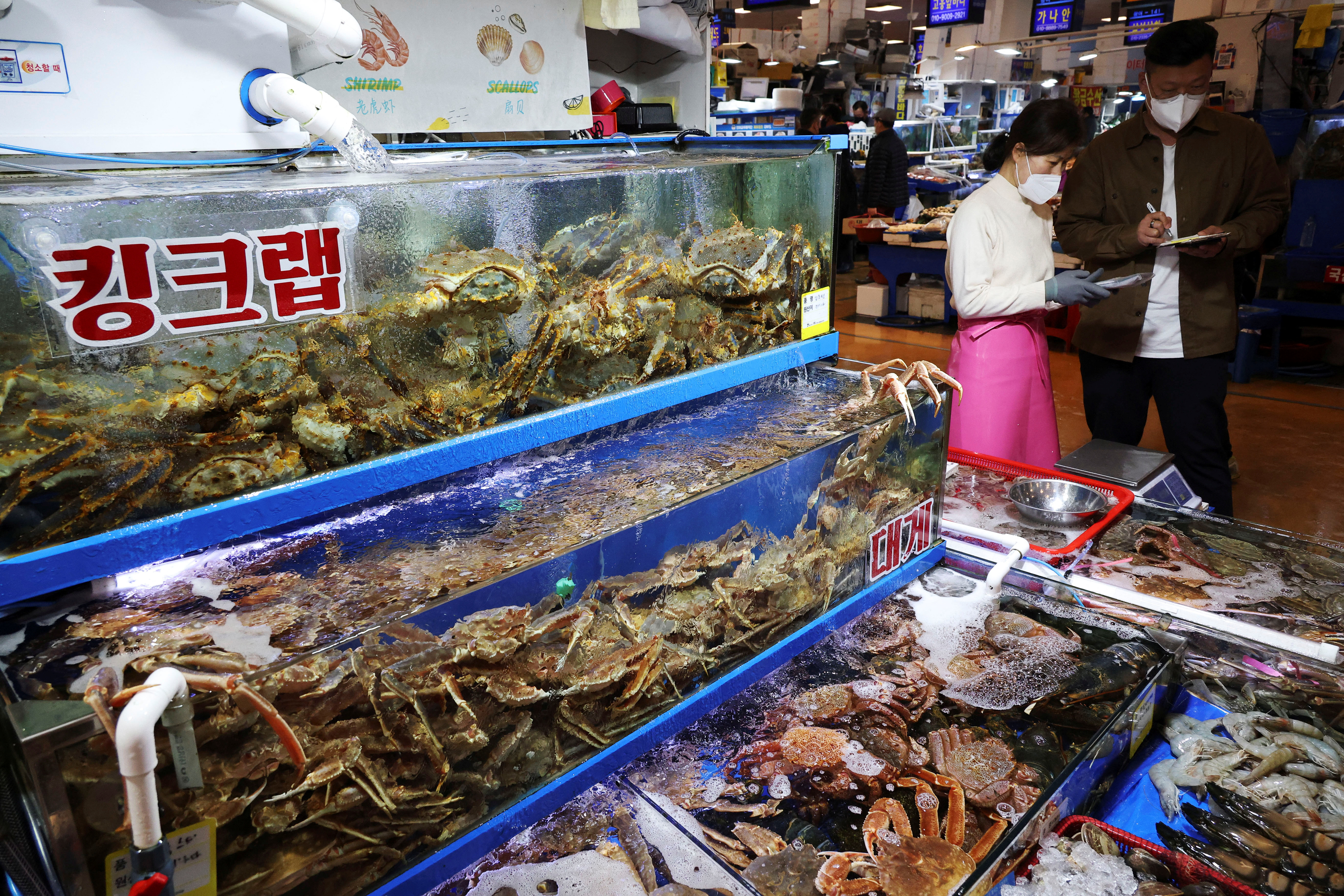 A man shops crabs, imported from Russia, at Noryangjin Fisheries Wholesale Market, in Seoul