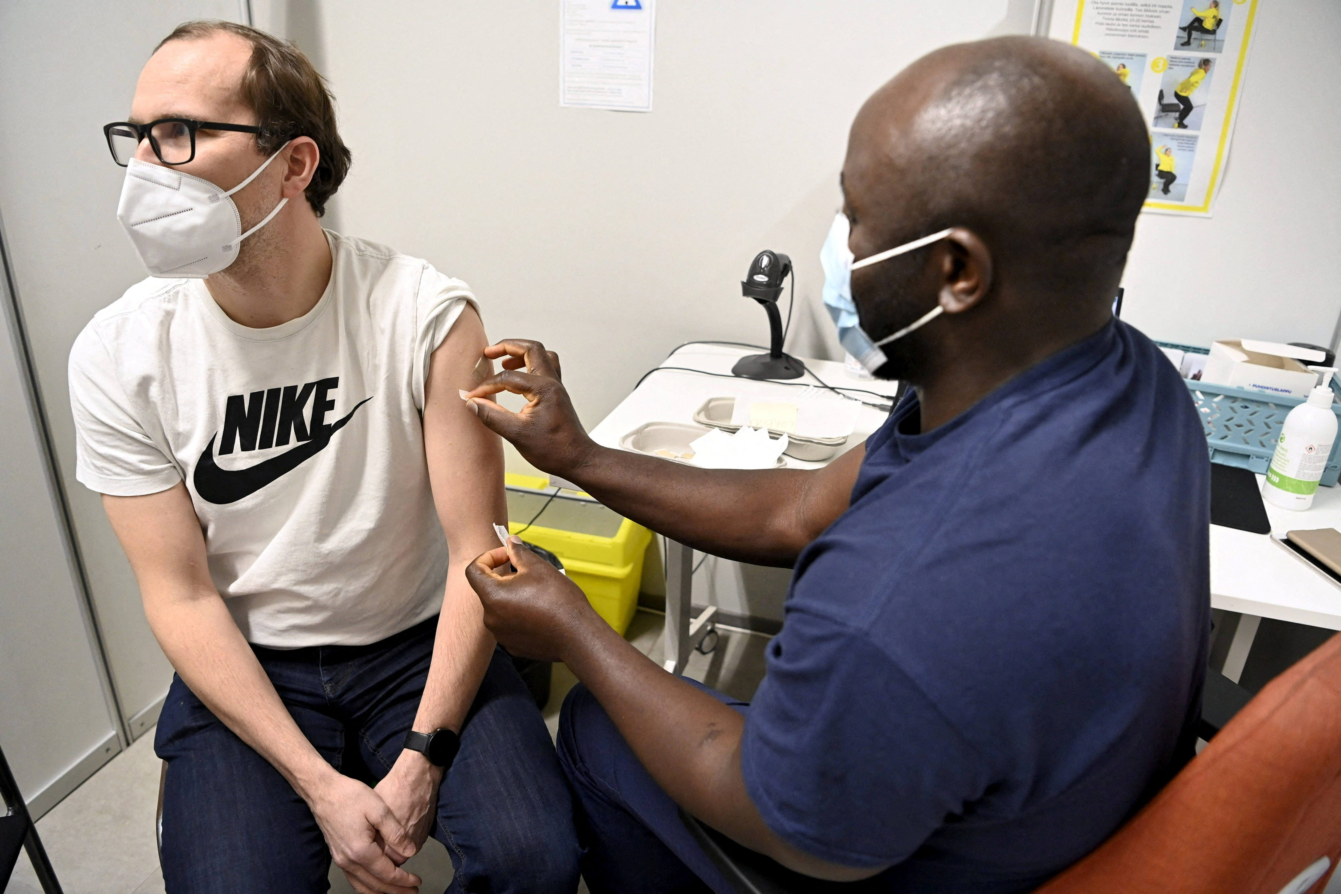 Man receives a booster dose of the coronavirus disease (COVID-19) vaccine in Espoo