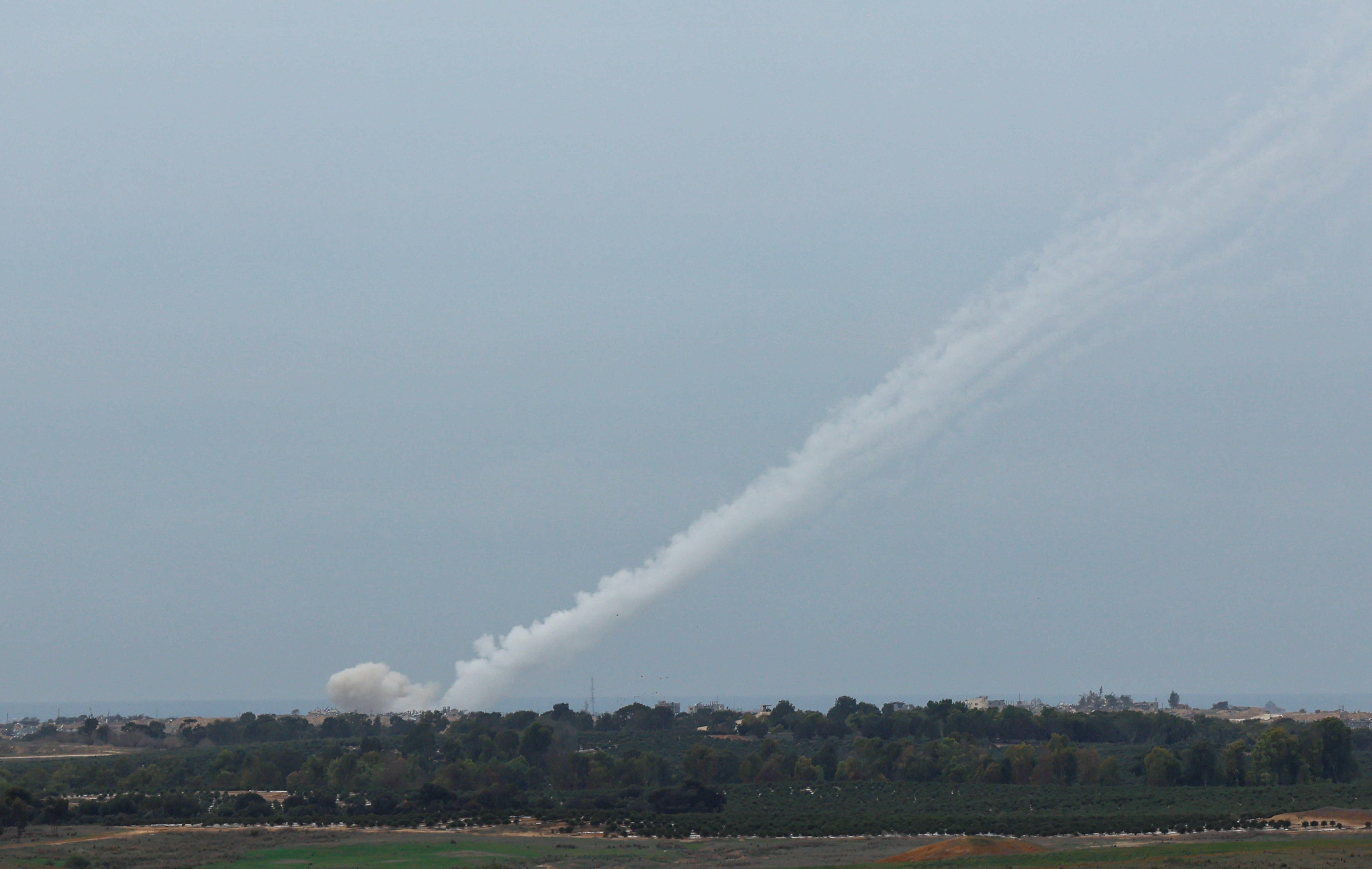 Smoke trails are seen as a salvo of rockets are launched from the Gaza Strip into Israel, as seen from southern Israel