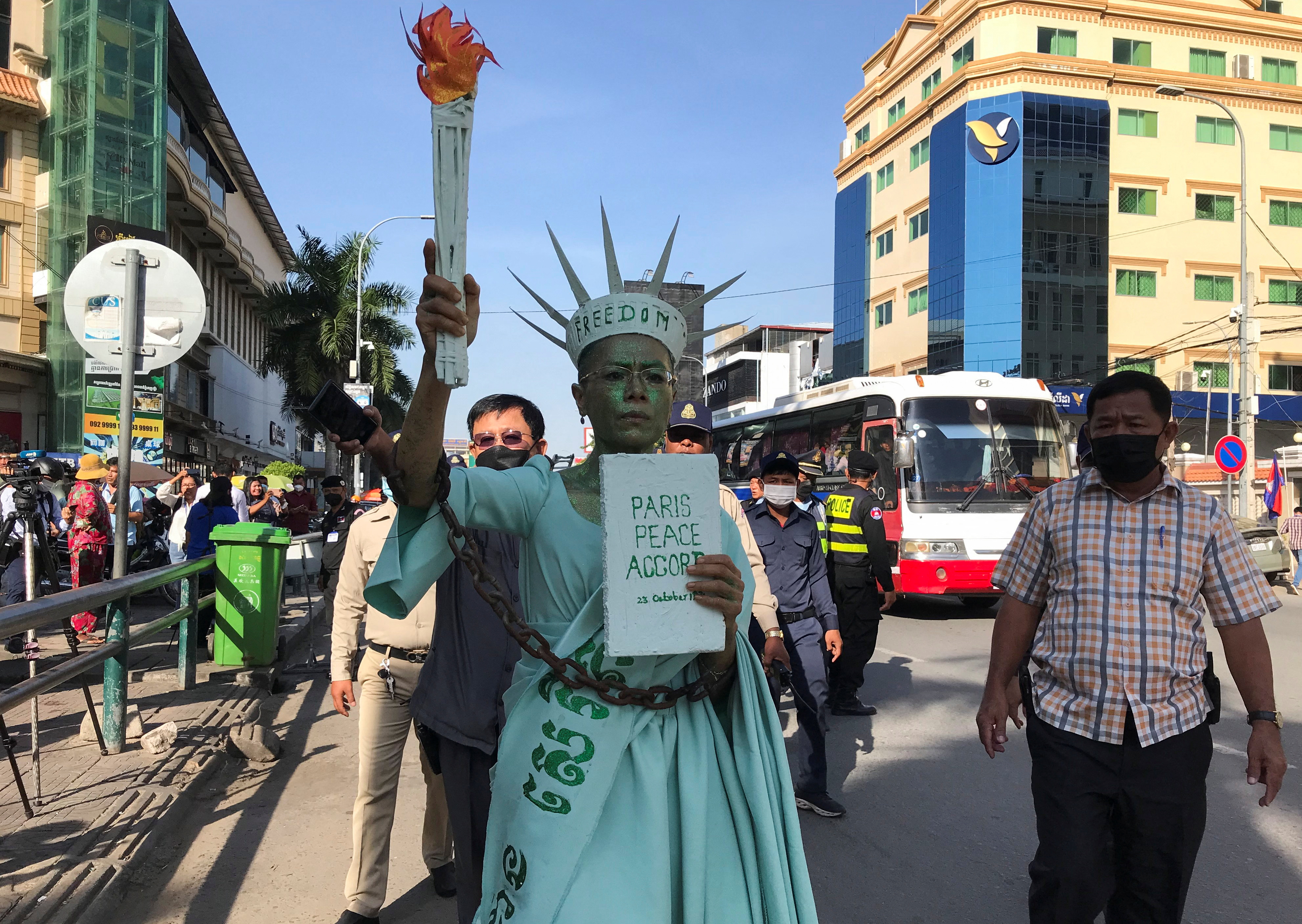 Theary Seng arrives dressed up as a chained Statue of Liberty for her treason verdict at Phnom Penh Municipal Court