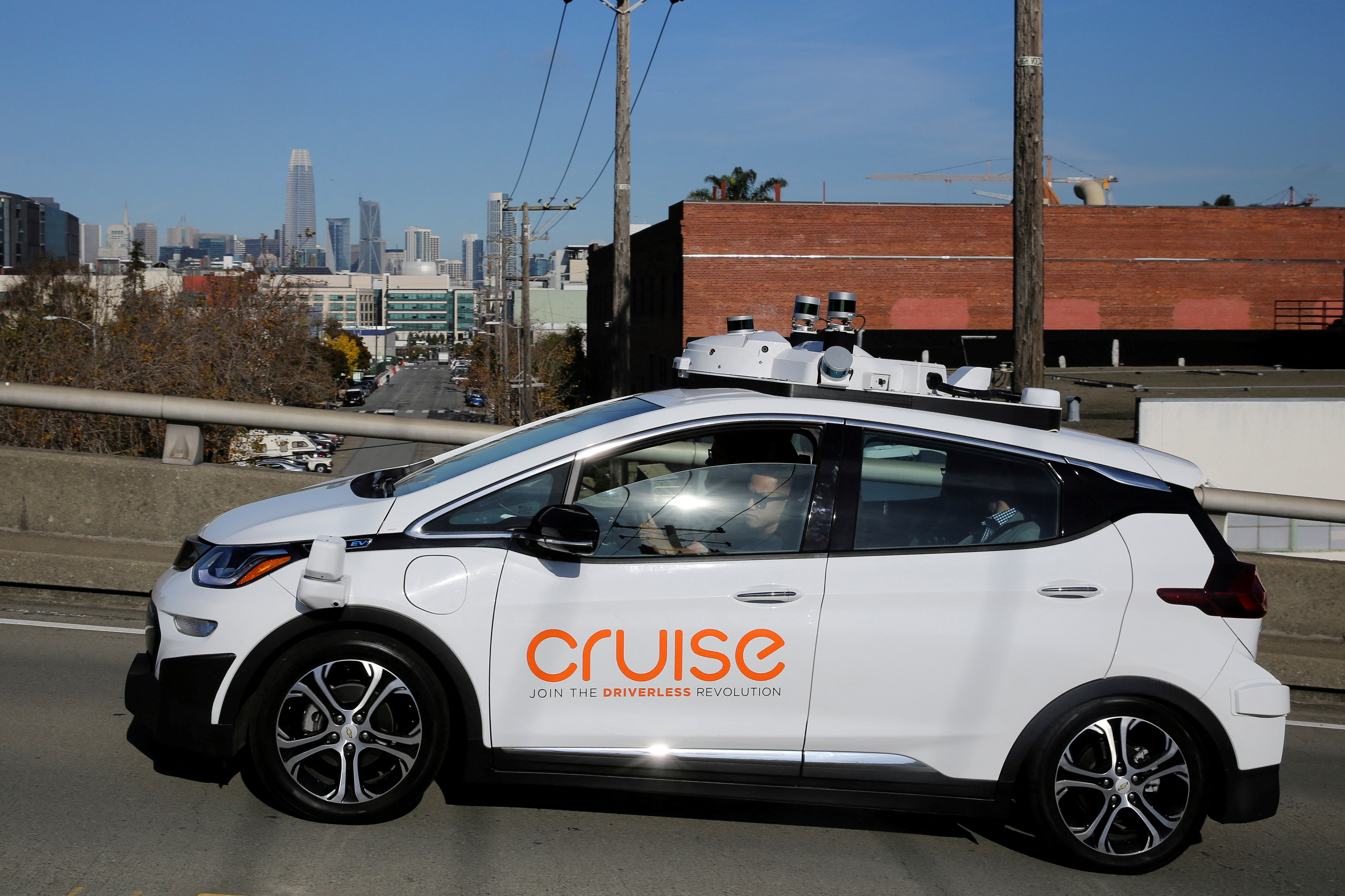 The San Francisco skyline is seen behind a self-driving GM Bolt EV during a media event where Cruise, GMÕs autonomous car unit, showed off its self-driving cars in San Francisco