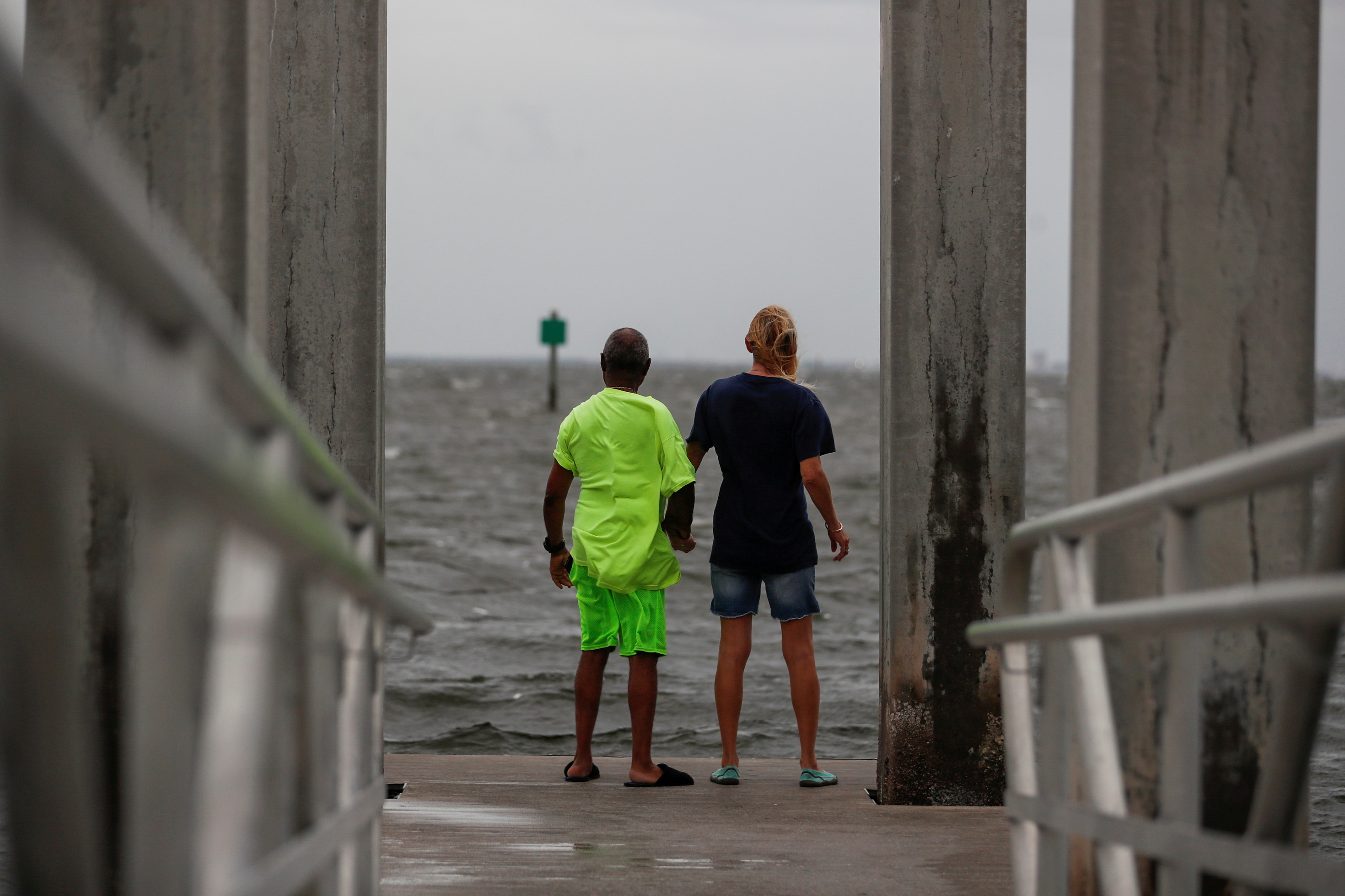 Way Williams, 65, and his wife Jennifer, 60, stand holding hands at Bay Vista Park, as Elsa strengthened into a Category 1 hurricane hours before an expected landfall on Florida's northern Gulf Coast, in St. Petersburg, Florida, U.S.  July 6, 2021. REUTERS/Octavio Jones