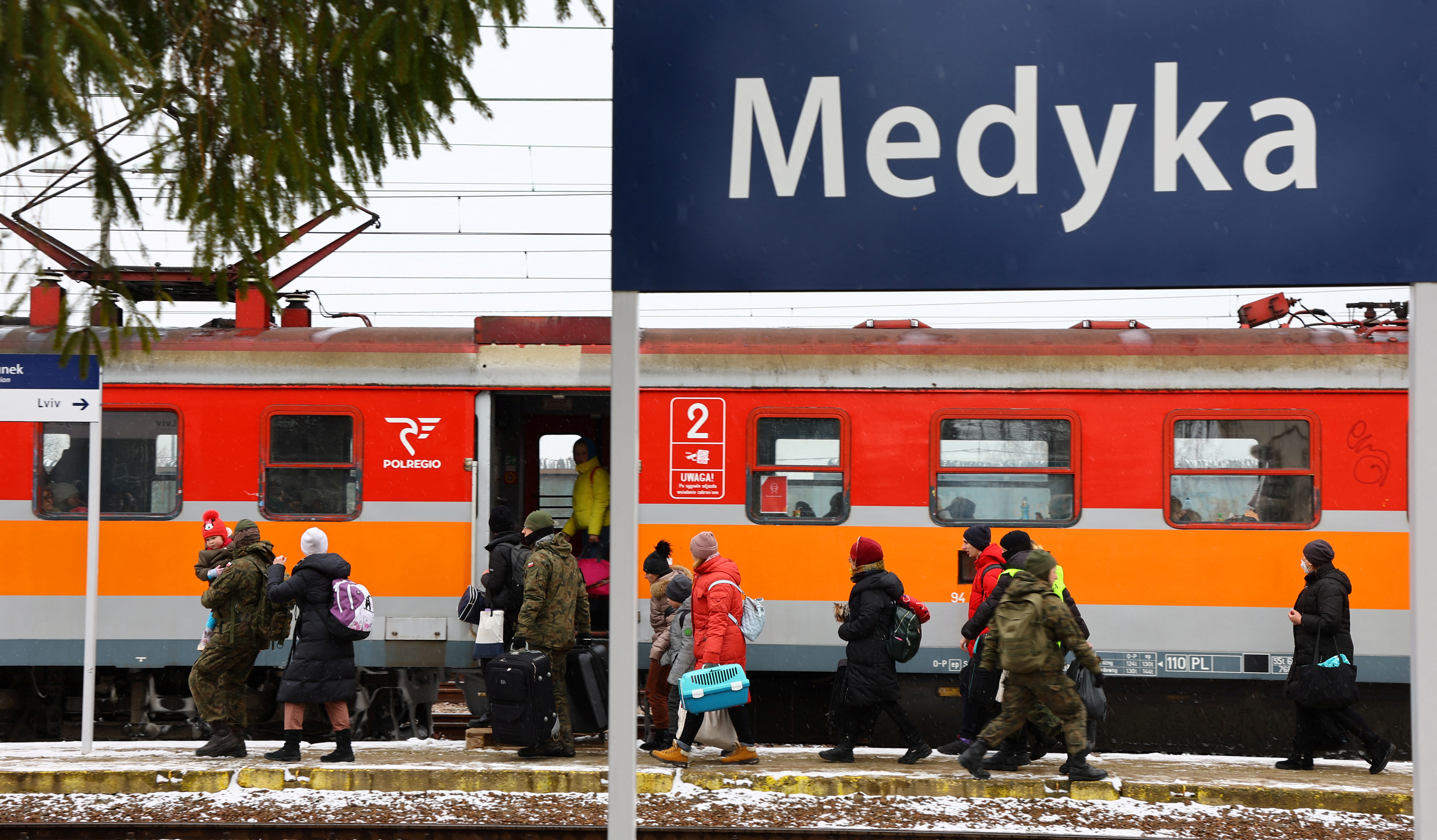 People fleeing Russia's invasion of Ukraine arrive at the border checkpoint in Medyka