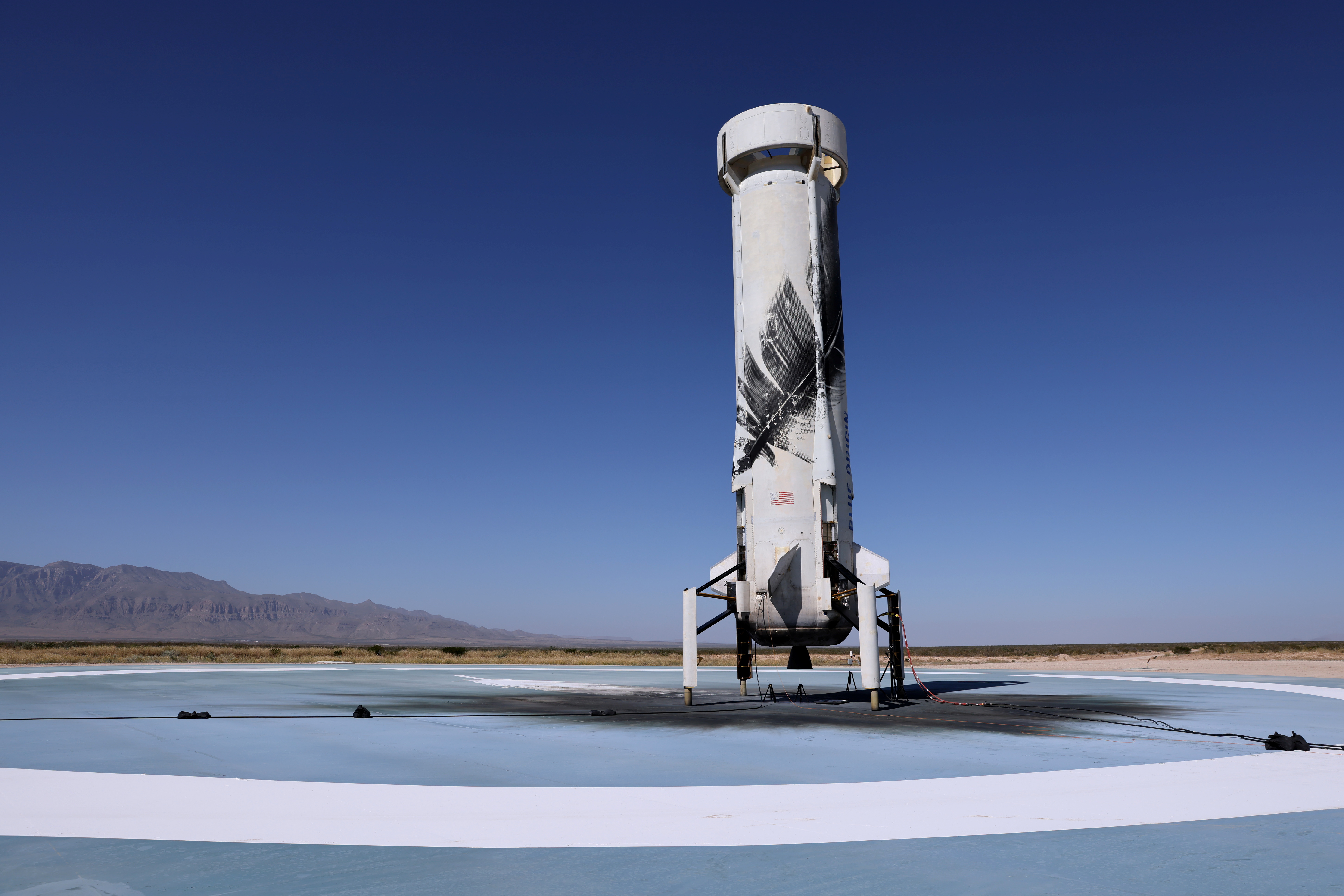 Blue Origin's reusable rocket engine New Shepard is seen on a landing pad after carrying a capsule with Star Trek actor William Shatner, 90, and three others on billionaire Jeff Bezos's company's second suborbital tourism flight near Van Horn, Texas, U.S., October 13, 2021. REUTERS/Mike Blake