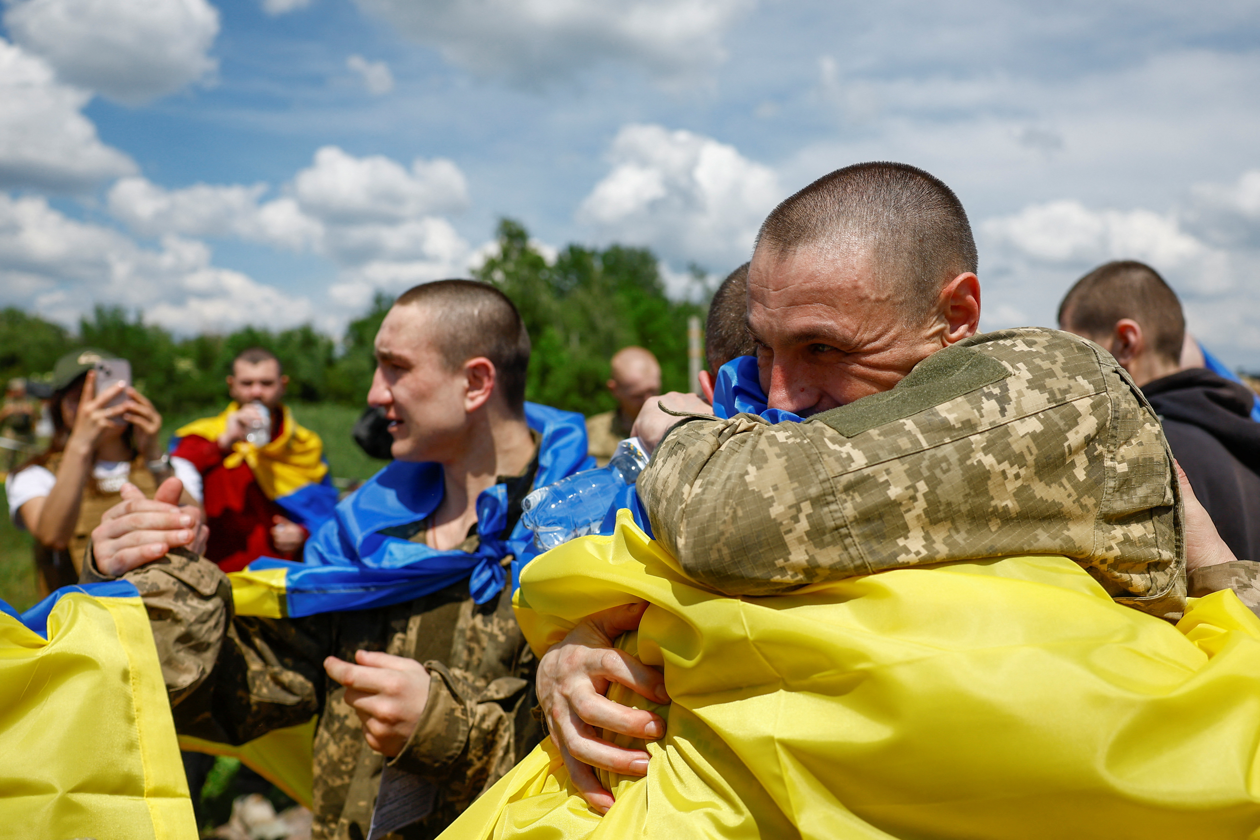 Ukrainian POWs react after a swap at an undisclosed location in Ukraine